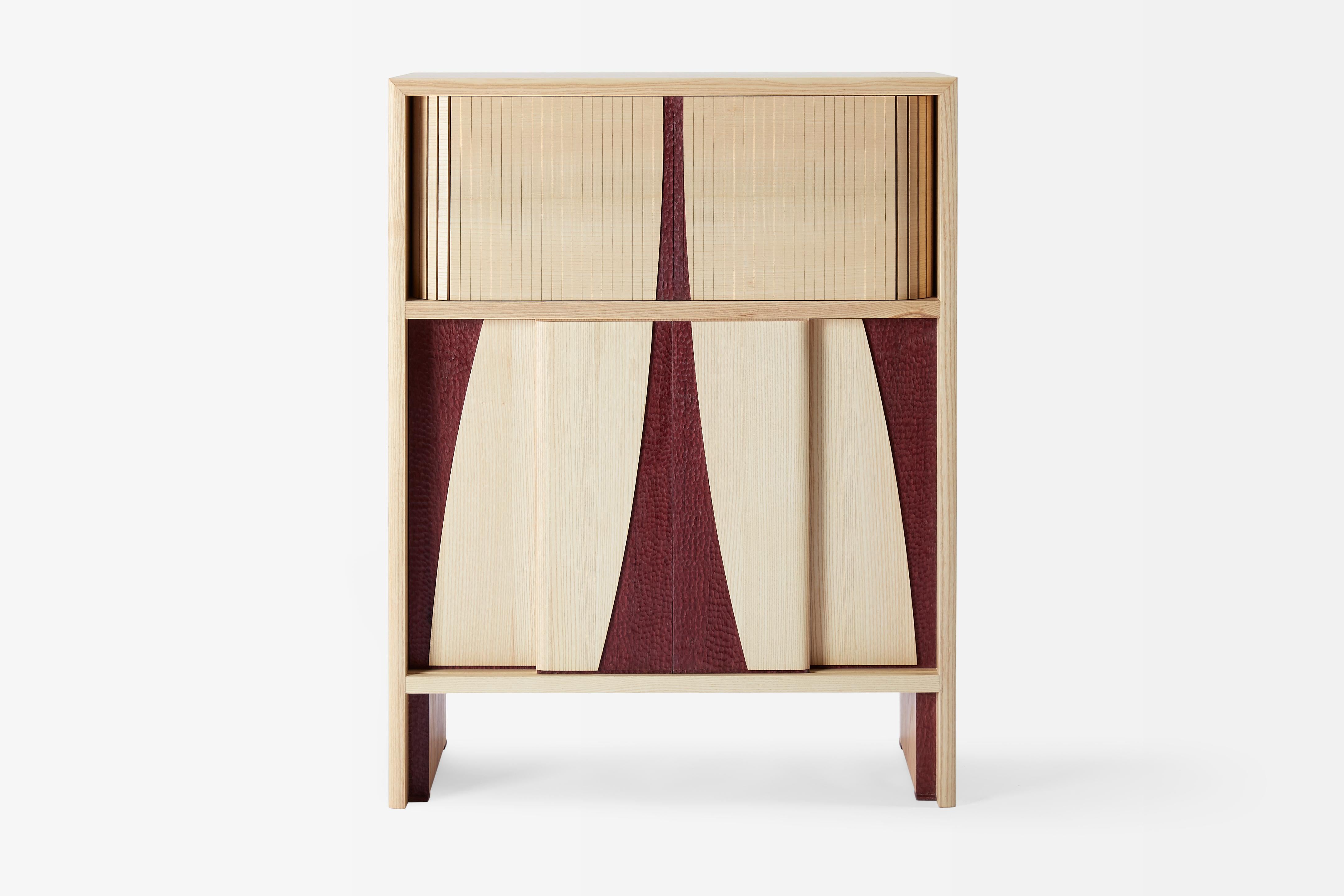 Wine Cabinet I is handcrafted using White Ash, Purple Heart and Ebony. The lower half has four sliding doors to allow for easy access to all of your bottles. There is also a small drawer designed specifically to hold your favourite cork screw. The