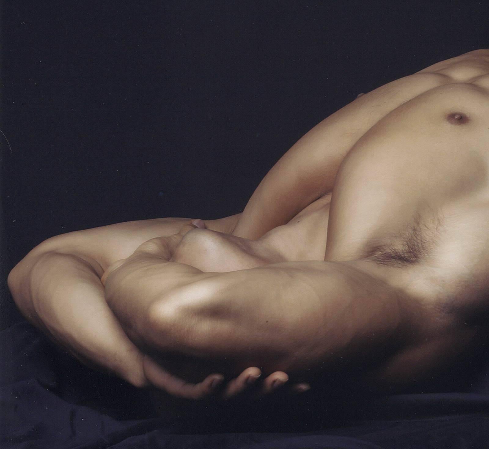 Male Nude #135 (young male nude lying with raised arms folded across his face) - Photograph by Dylan Ricci