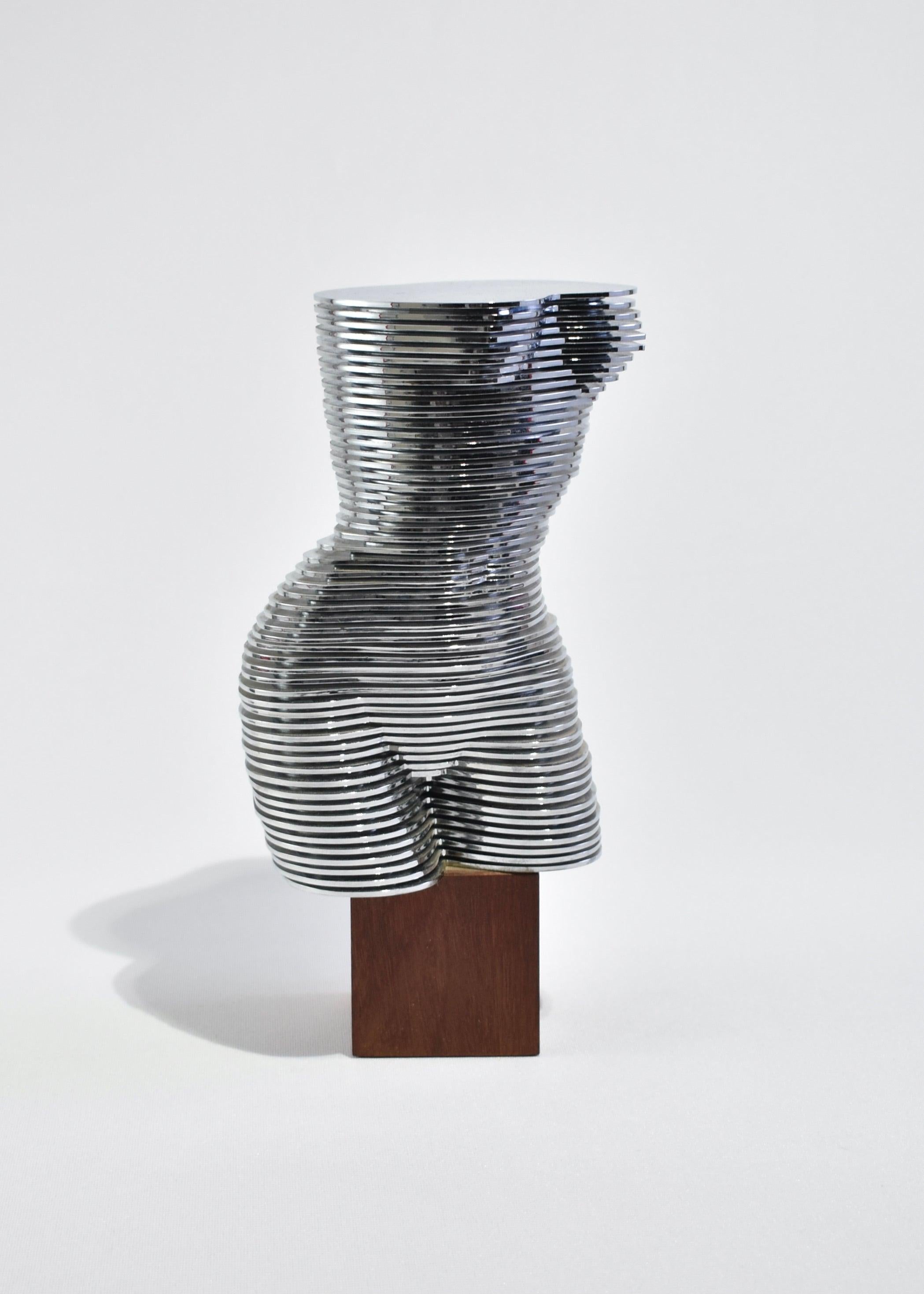 Rare, dynamic woman torso sculpture 'Eva' made of 55 different sized chromed plastic discs that spin on a central metal axis on wooden base. Each disc can be individually moved to form an abstract sculpture. Eva was produced for the 46th Venice