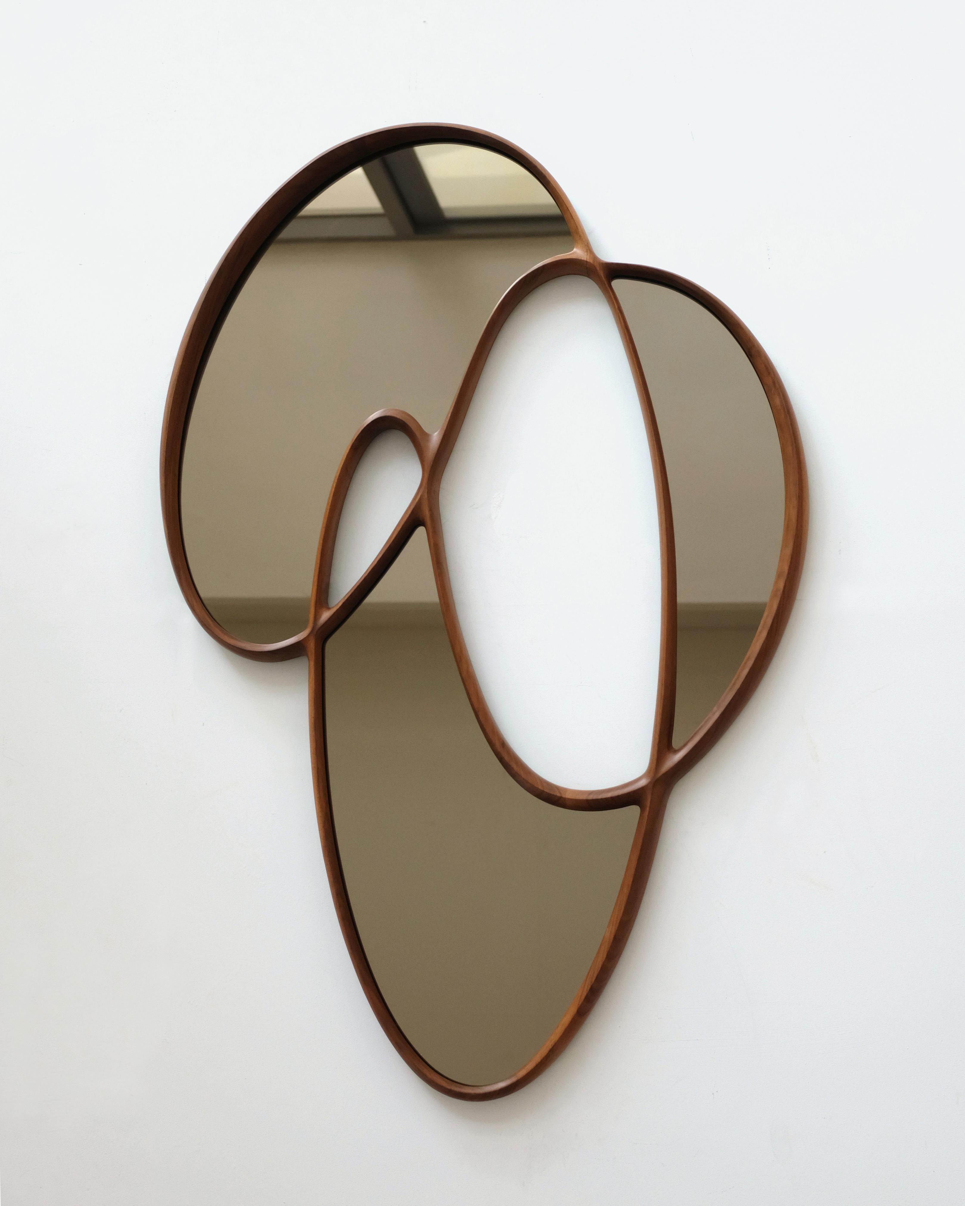 'Dynamic Mirror I' by Soo Joo is a statement wooden wall mirror with a unique and timeless asymmetric form. It hangs flush to the wall with custom-made steel French cleats, and can be hung horizontally or vertically.

This organic mirror silhouette