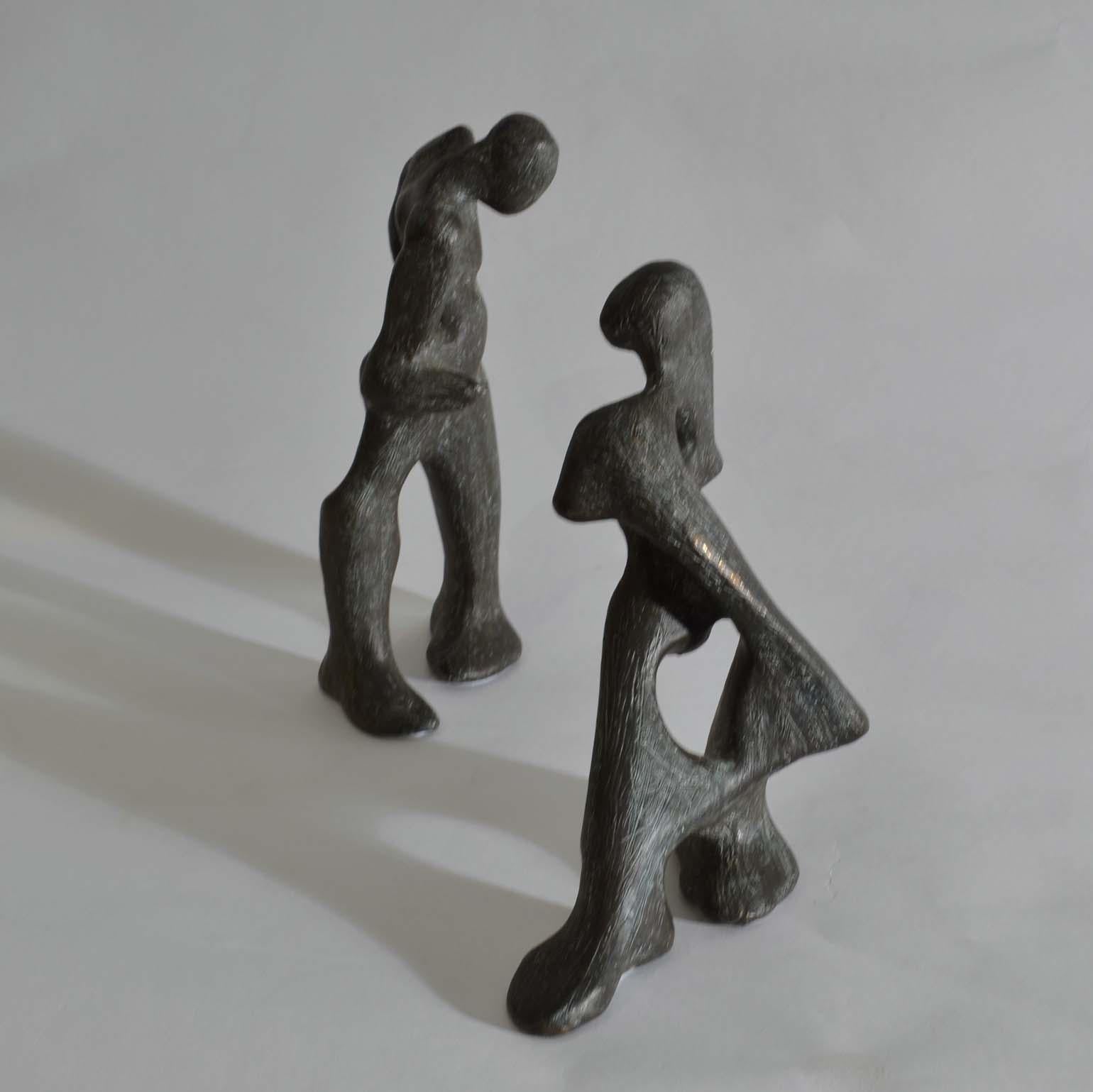 Dynamic and playful sculptures of dancing pair. They are free standing male and female figures cast in bronze with a scratched textured patina. The biomorphic figures can be positioned in any formation, reacting differently to each others stance as