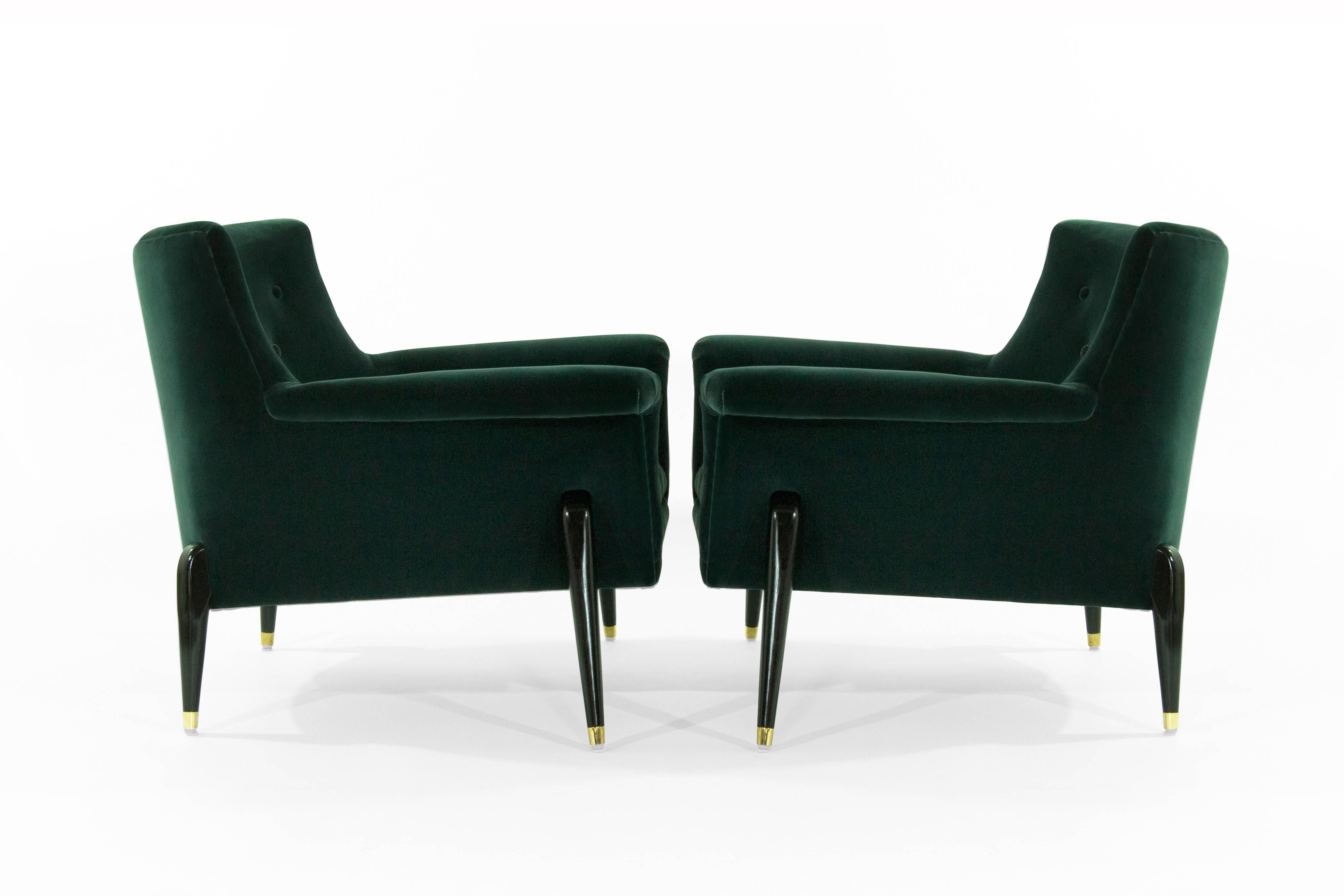 Pair of significant Italian spider leg lounge chairs in the style of Ico Parisi or Jean Royére, all of the exposed wooden legs are ebonized in black polished with brass sabots, the chairs have been recently reupholstered in a high-quality tourmaline