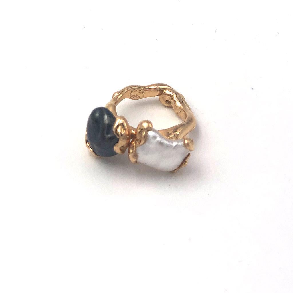 Inspired by the flowing nature of the sea, Lucifer vir Honestus’ elegant designs present organic, handmade metal work that illuminates the oneiric beauty of natural crystals.

This ring features a white and black pearl, set in rose gold.