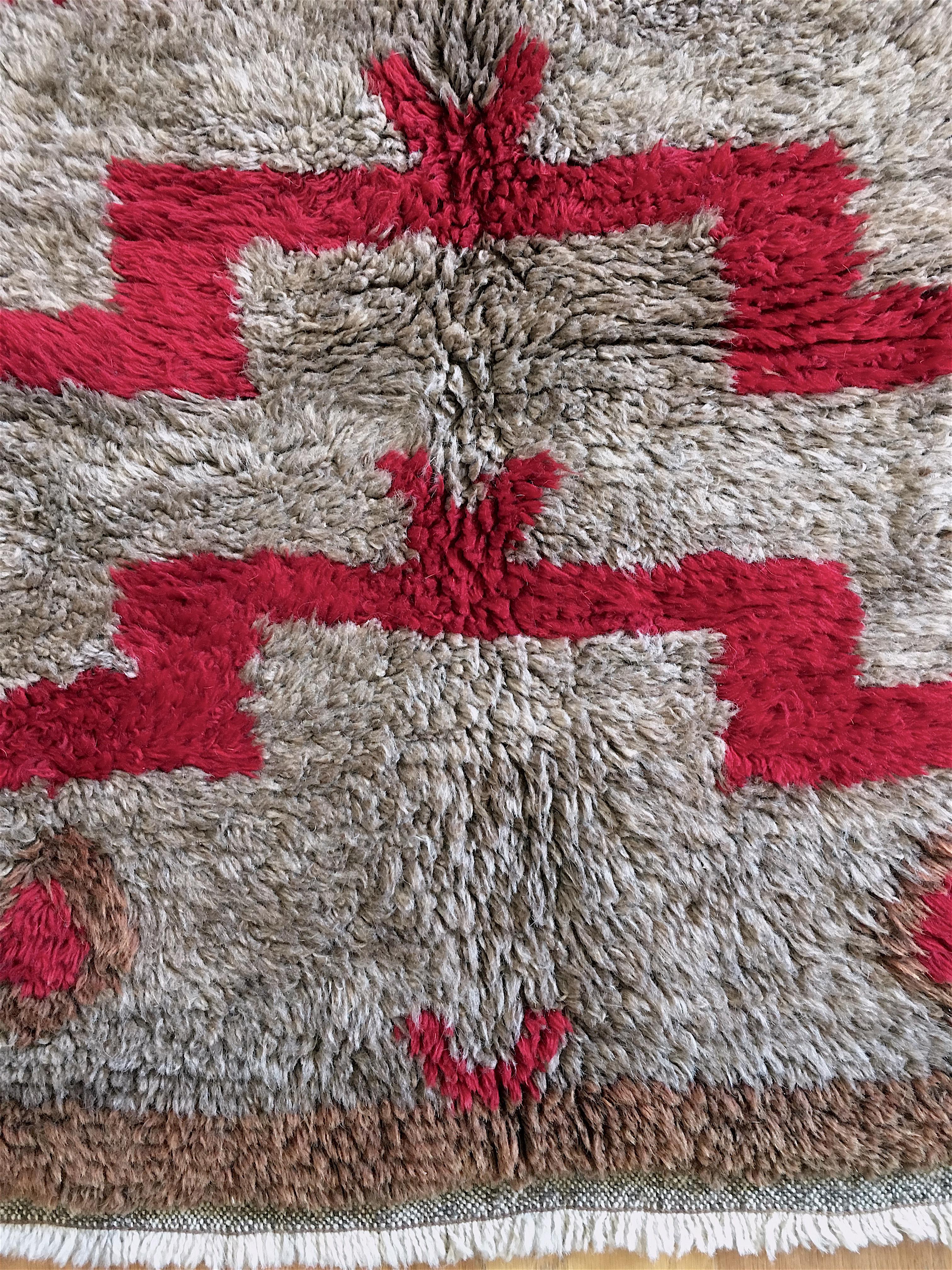 Charming Turkish Tulu or sleeping rug, of mid-20th century vintage, from central Anatolia, with full, thick pile, in natural, undyed wool, along with a main motif rendered in red, and a border of tawny brown. An interesting addition is the blue dot,