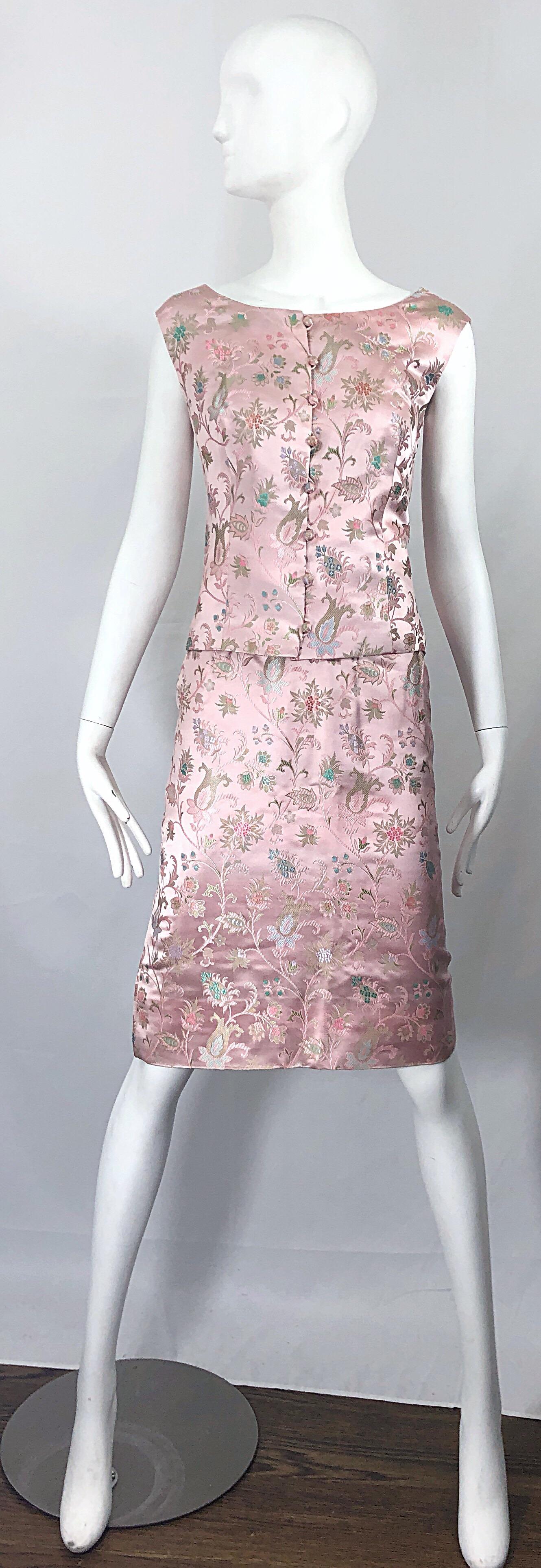 Utterly chic vintage 60s DYNASTY 3 piece light pink silk dress ensemble! The most beautiful light pink silk with intricate embrodiery in blues, greens, pinks and lavender purple throughout. 
Features a sleeveless top that buttons up the front.