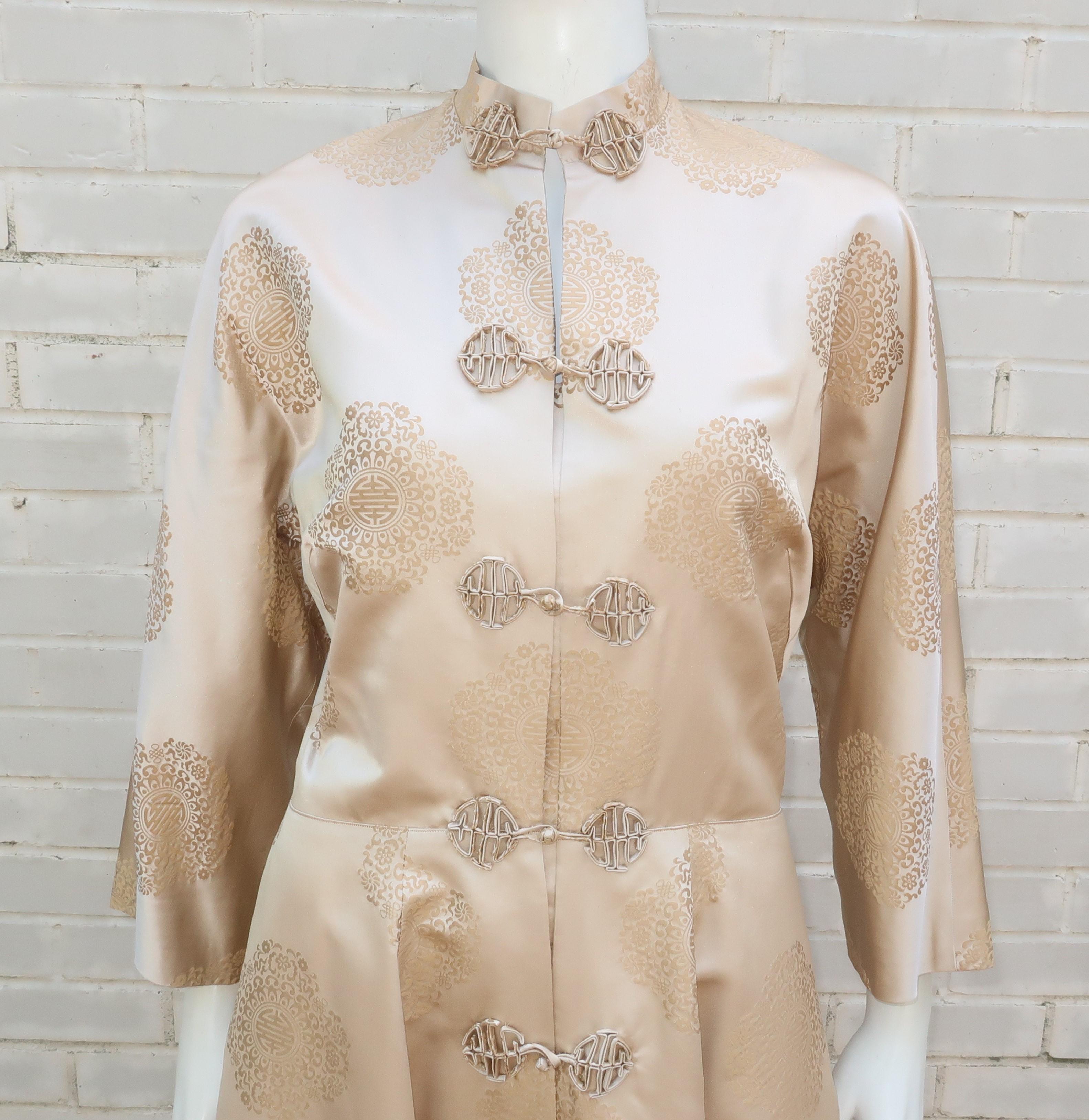 1950's champagne silk jacquard coat with an Asian motif accented by a mandarin style silhouette, beautiful pattern and frog closures.  The coat is fully lined and can be worn as a dress, hostess robe or outerwear.  It was created by Dynasty, a Hong