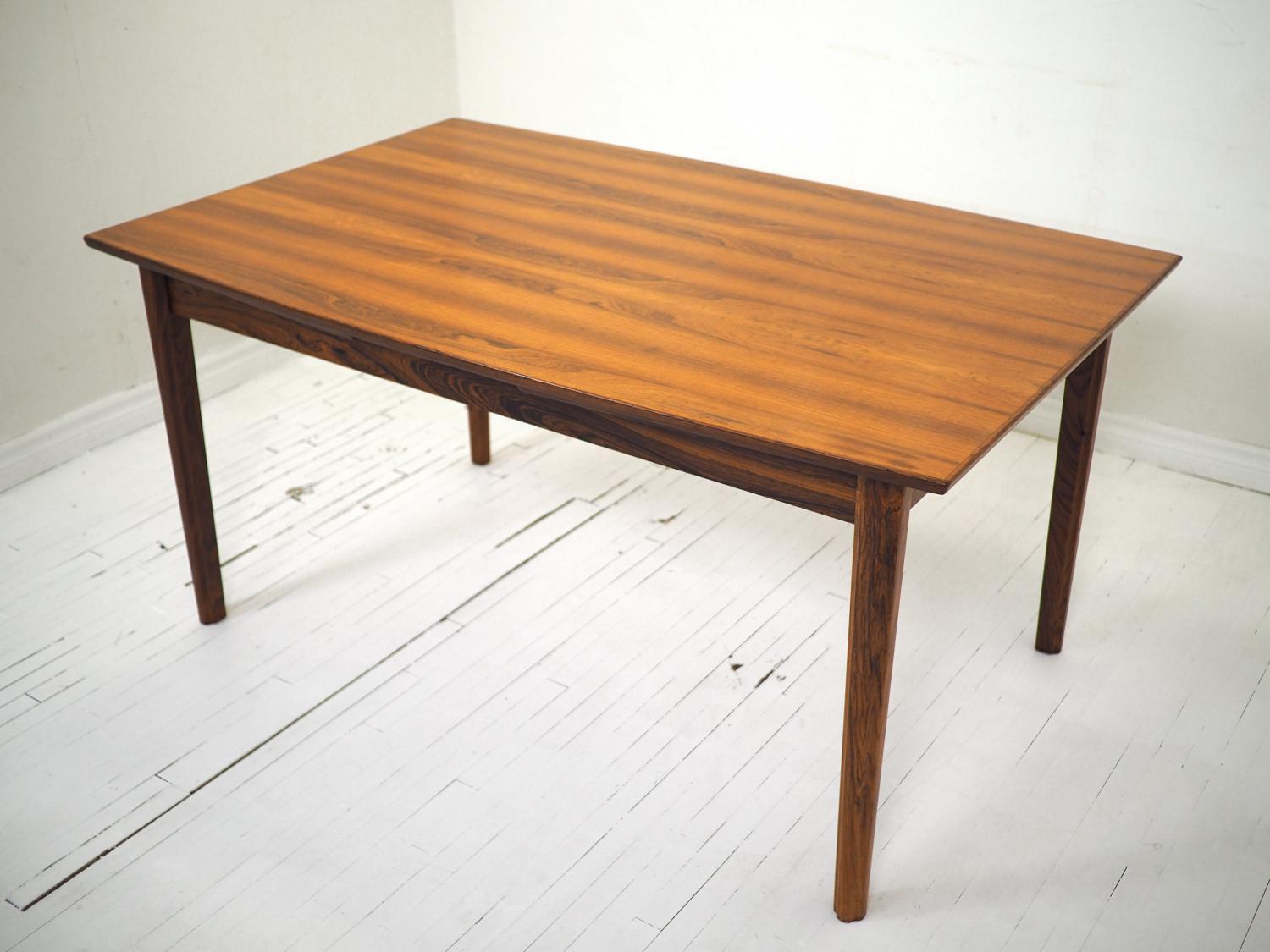 Beautiful early Dyrlund dining table in rosewood, made in Denmark circa 1960's. Makers stamp present on underside. 

Exceptional condition. Rock solid joinery, no signs of damage or repairs. Even the finish is in immaculate condition for the age -