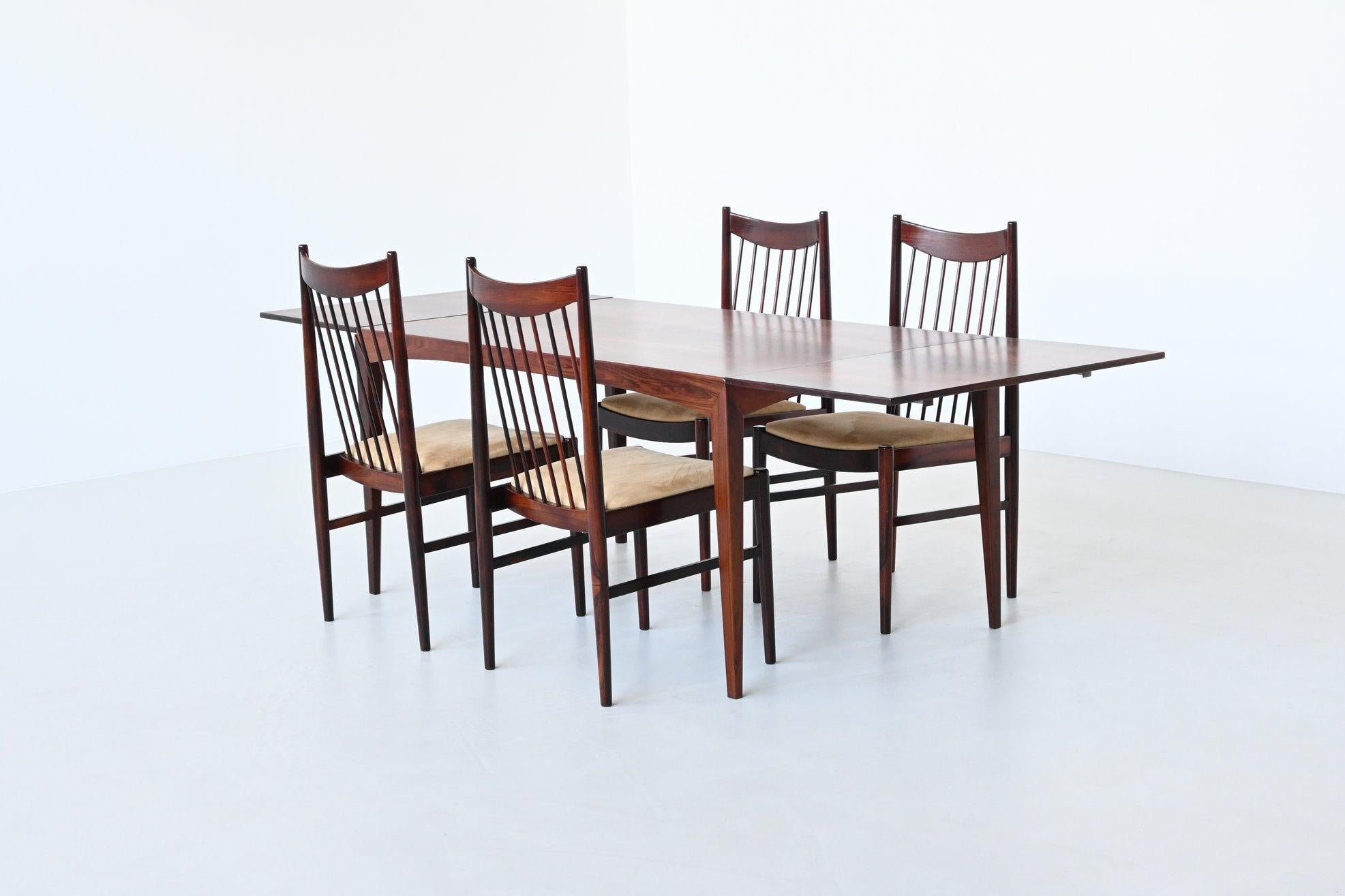 Beautiful shaped extendable dining table manufactured by Dyrlund, Denmark 1960. This well-crafted table is characterized by a strong and solid construction executed in rosewood. This is realized by the sharp and clear lines which are visible in the