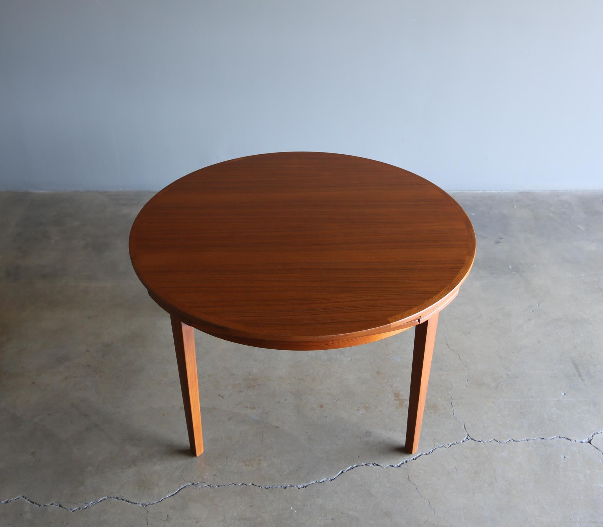 Dyrlund teak flip flap lotus dining table, circa 1965. This table expands to 68.75