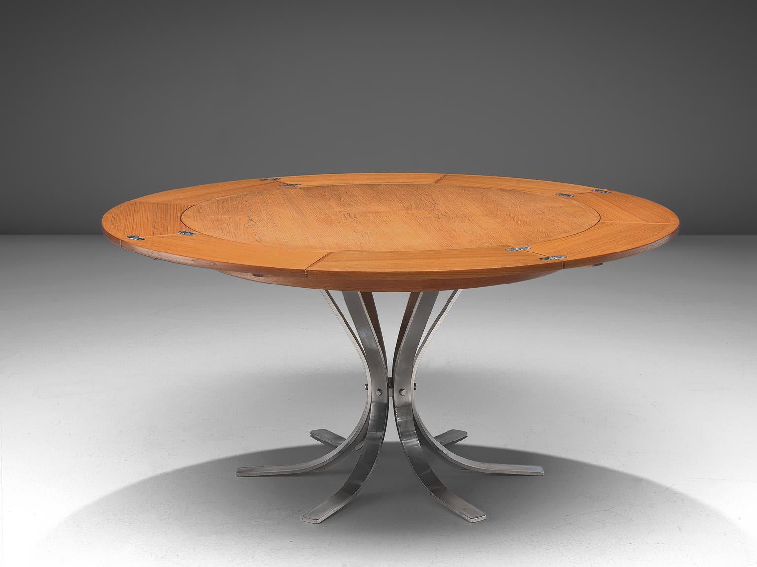 Round extend-able pedestal table, teak and steel, Dyrlund, Denmark, 1960s.

This circular, extendable table has a pedestal chrome base in a six star model and is finished with a teak top. The top has the ability to extend in diameter. Four