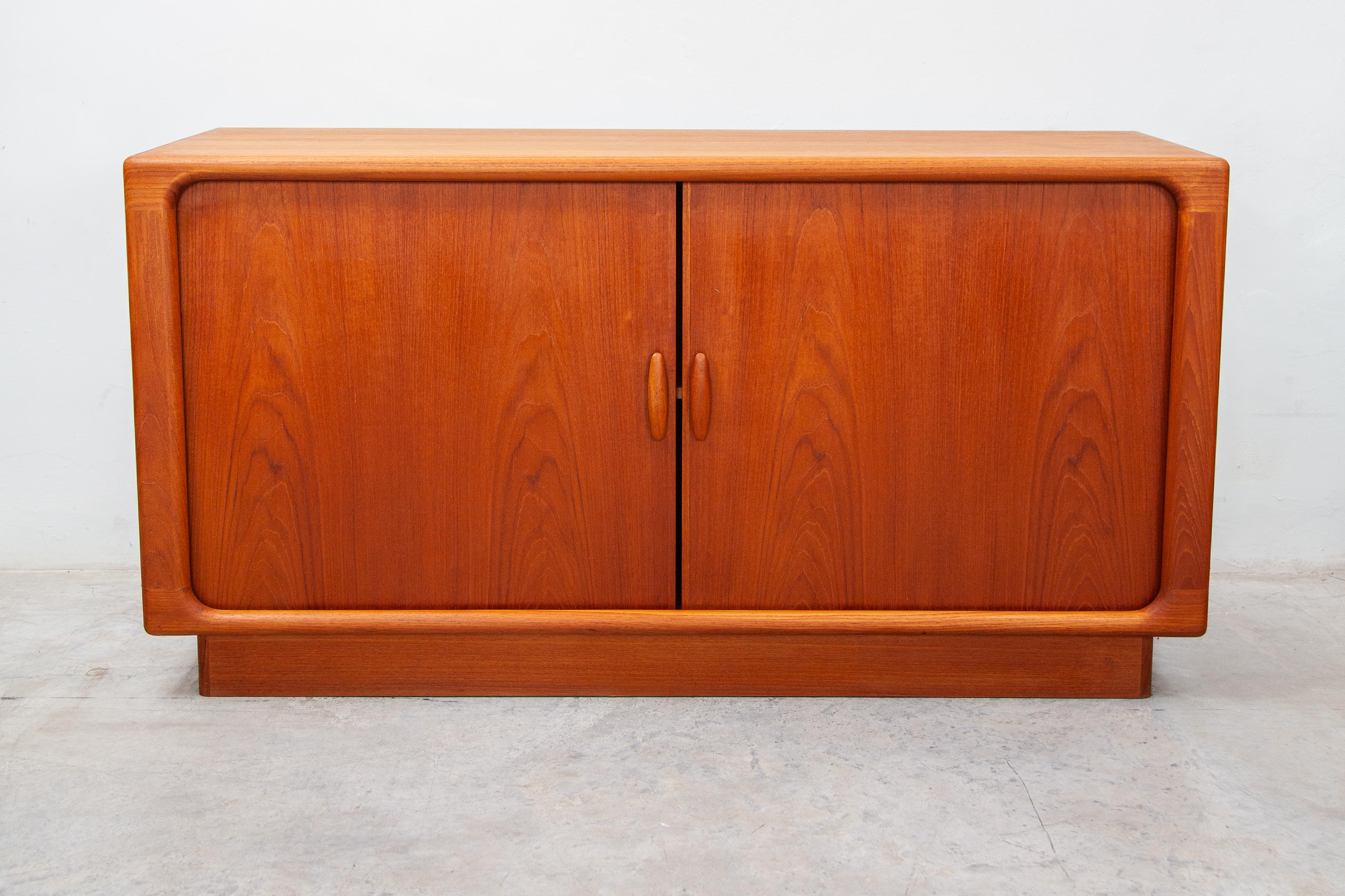 Beautiful teak sideboard made with Danish craftsmanship with two sliding doors, in perfect condition. A must have for your interior.