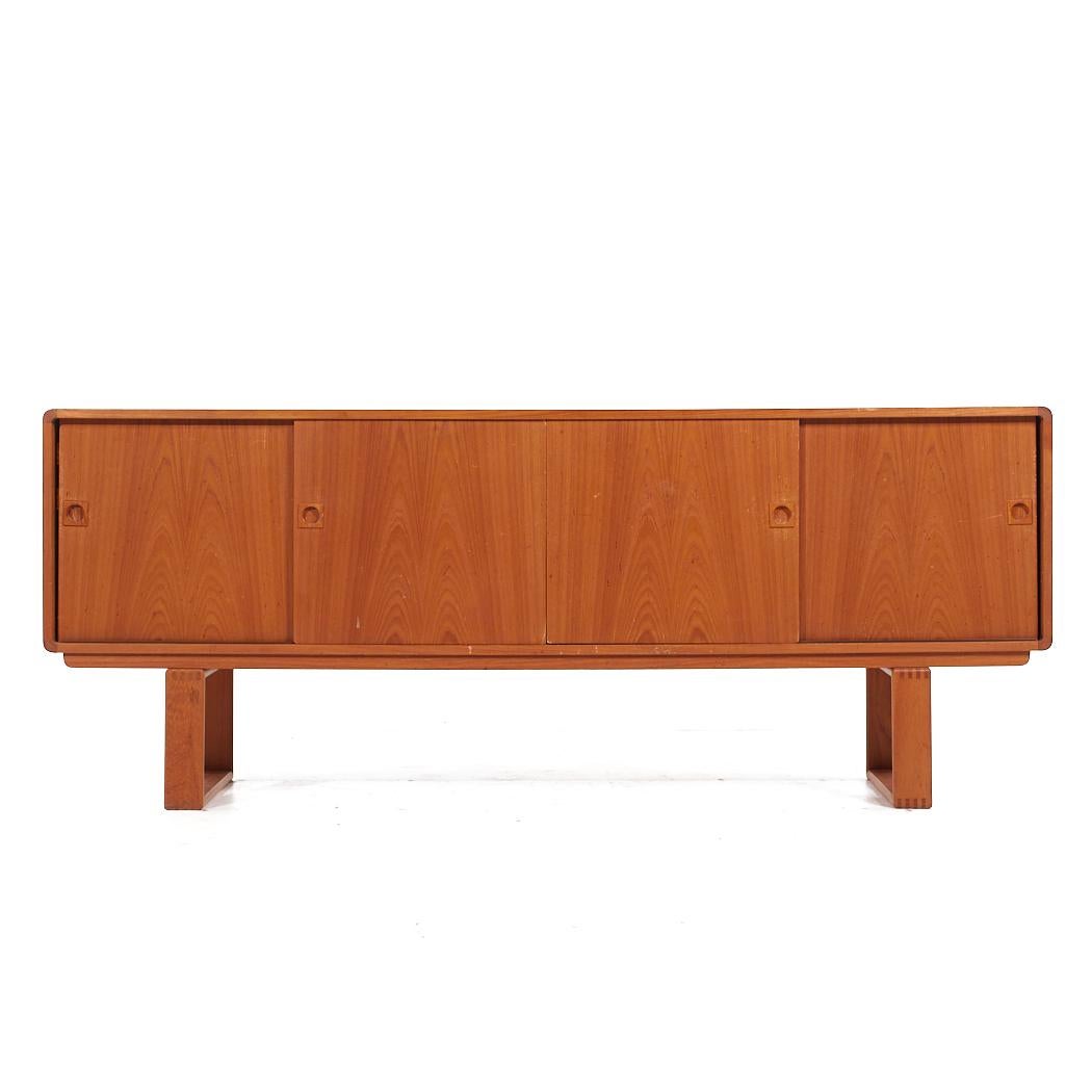 Dyrlund Mid Century Danish Teak Sleigh Leg Credenza

This credenza measures: 78.75 wide x 18 deep x 31.5 inches high

All pieces of furniture can be had in what we call restored vintage condition. That means the piece is restored upon purchase so
