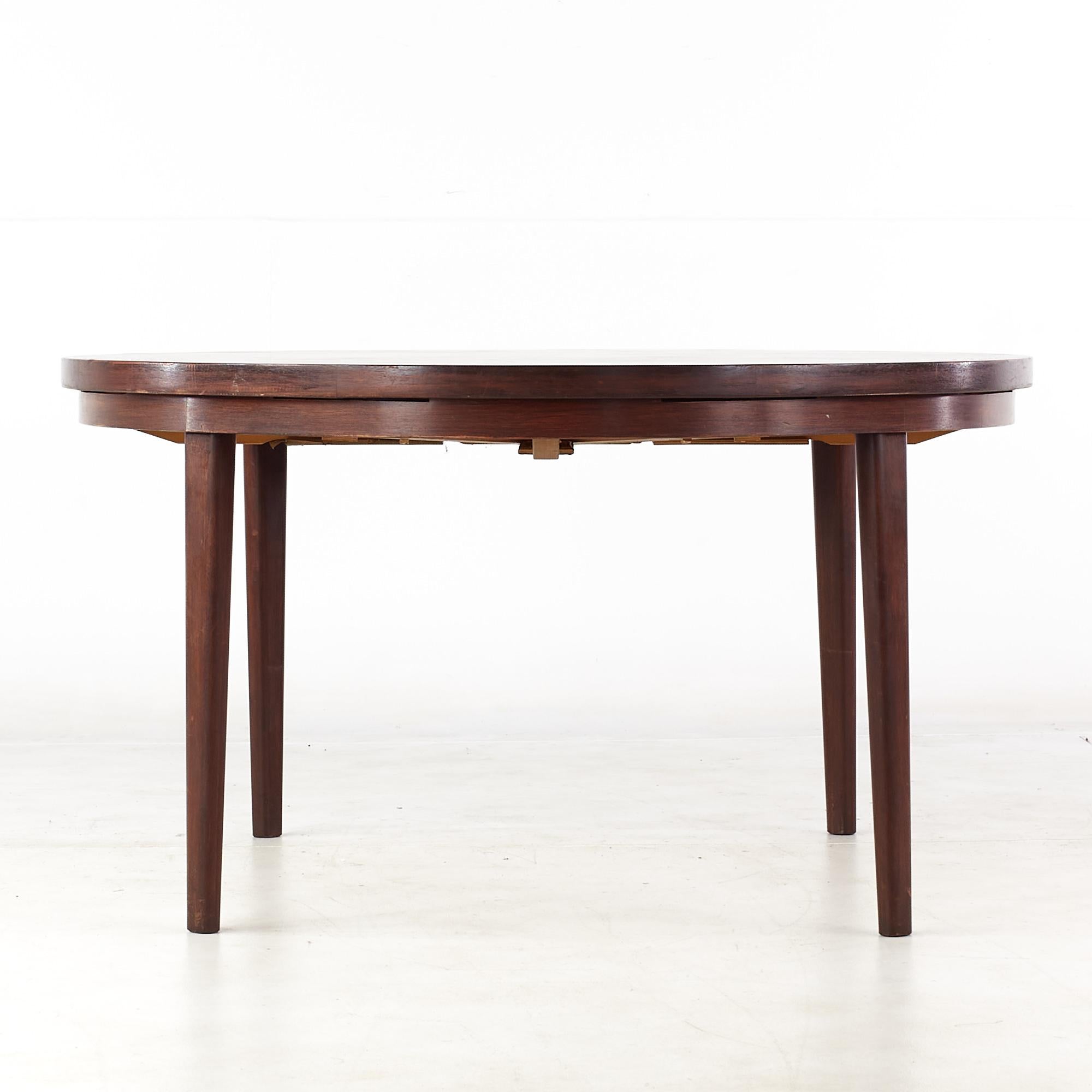 Dyrlund Mid century rosewood lotus round expanding dining table.

This table measures: 51.5 wide x 51.5 deep x 28 high, with a chair clearance of 24.25 inches.
The expanded measurements for this table are: 69 wide x 69 inches deep.

All pieces