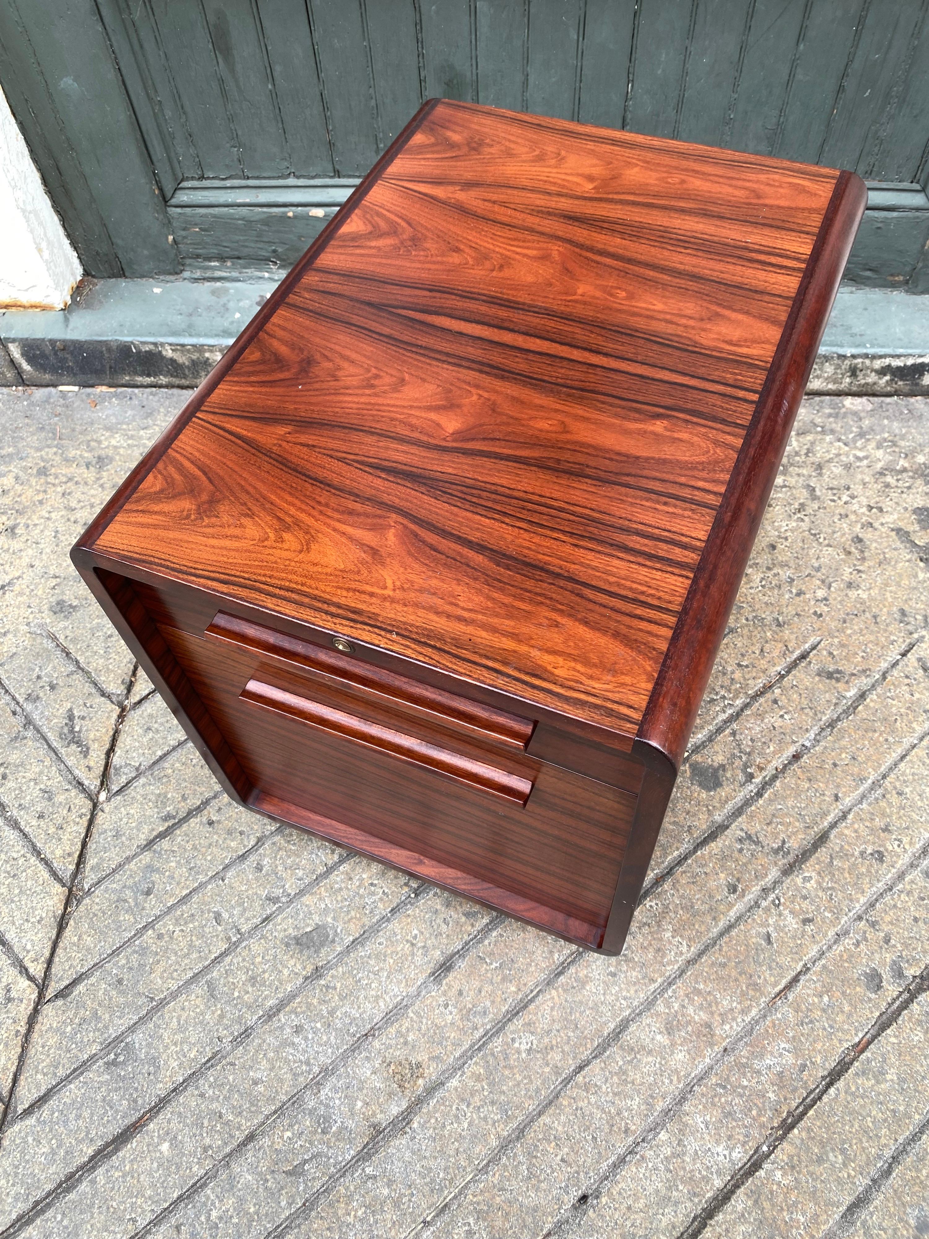 Dyrlund Rosewood Locking File cabinet on wheels. Bottom drawer is set up for hanging files. Rosewood is outstanding and in great shape! No fading, rosewood is rich and graining is very dramatic.  Cabinet has Key!