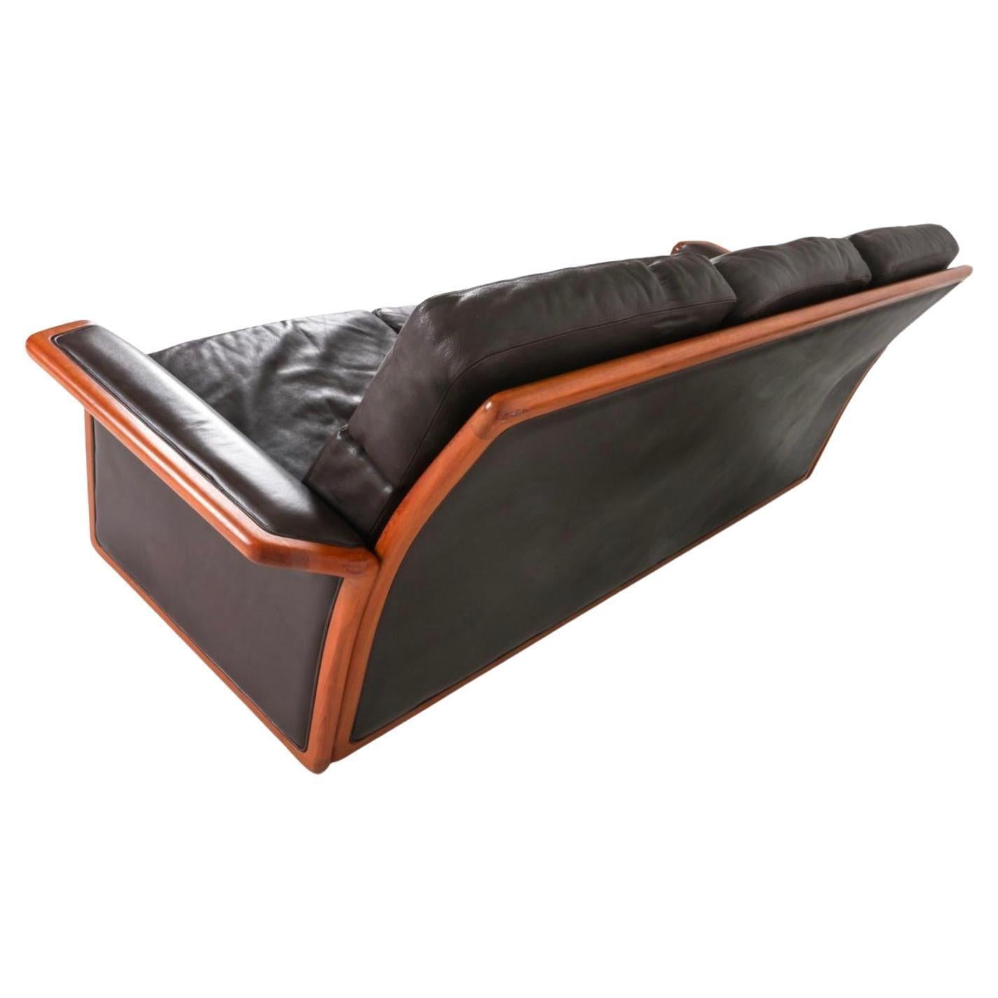 Dyrlund Danish Post Modern Teak and Brown Leather 3 seat Sofa, Circa 1980'S leather upholstery and cushions with teak frame and Accents. Labeled underneath. Made in Denmark. Located in Brooklyn NYC.

Very clean - Ready for Use.

Dimensions: W 86