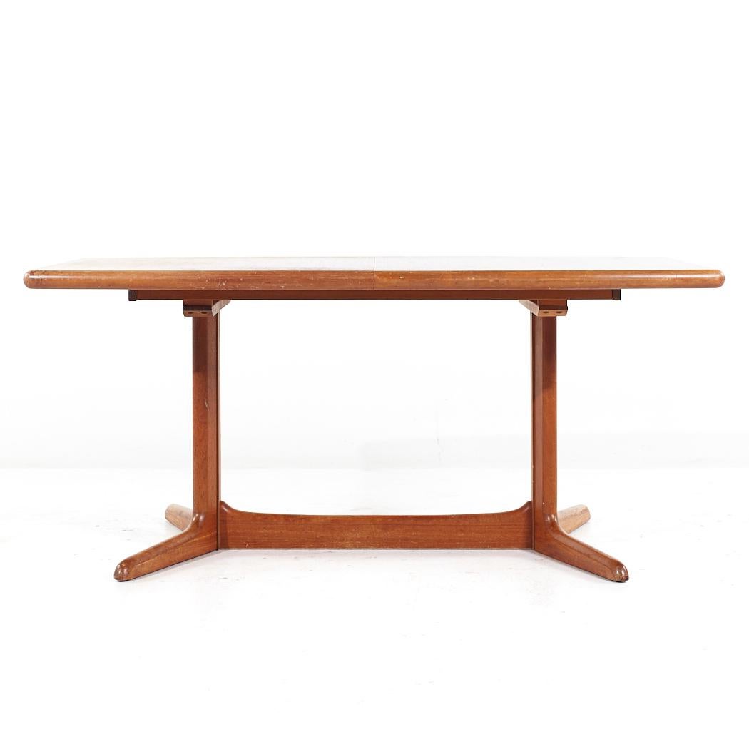 Dyrlund Style Mid Century Danish Teak Expanding Dining Table with 2 Leaves

This table measures: 64.75 wide x 39.5 deep x 29 inches high, with a chair clearance of 27.25 inches, each leaf measures 19.75 inches wide, making a maximum table width of