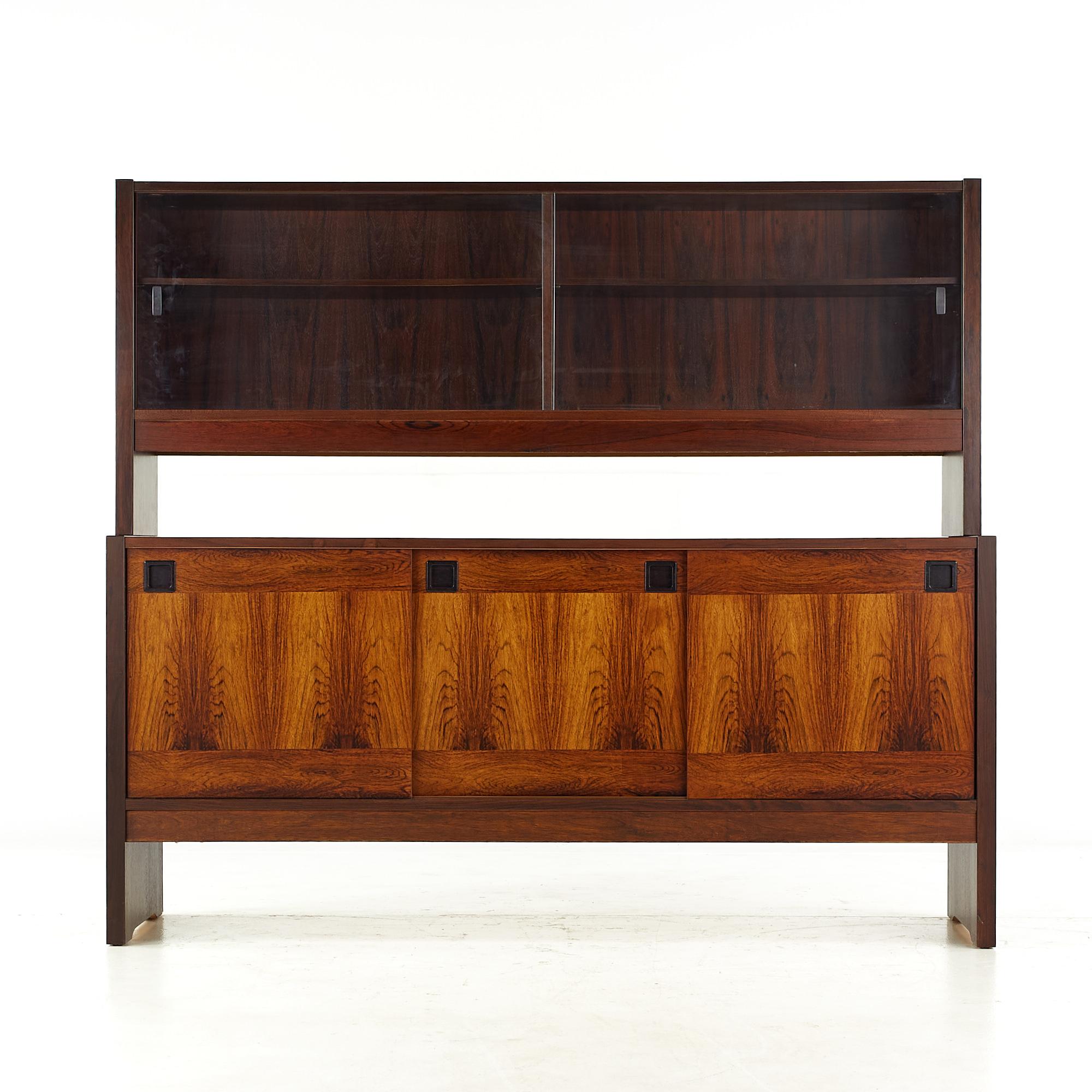 Dyrlund style mid-century rosewood buffet and hutch.

The buffet measures: 64.25 wide x 18 deep x 30 inches high
The hutch measures: 64.25 wide x 12.75 deep x 26.5 inches high
The combined height of the buffet and hutch is 56.5 inches

All