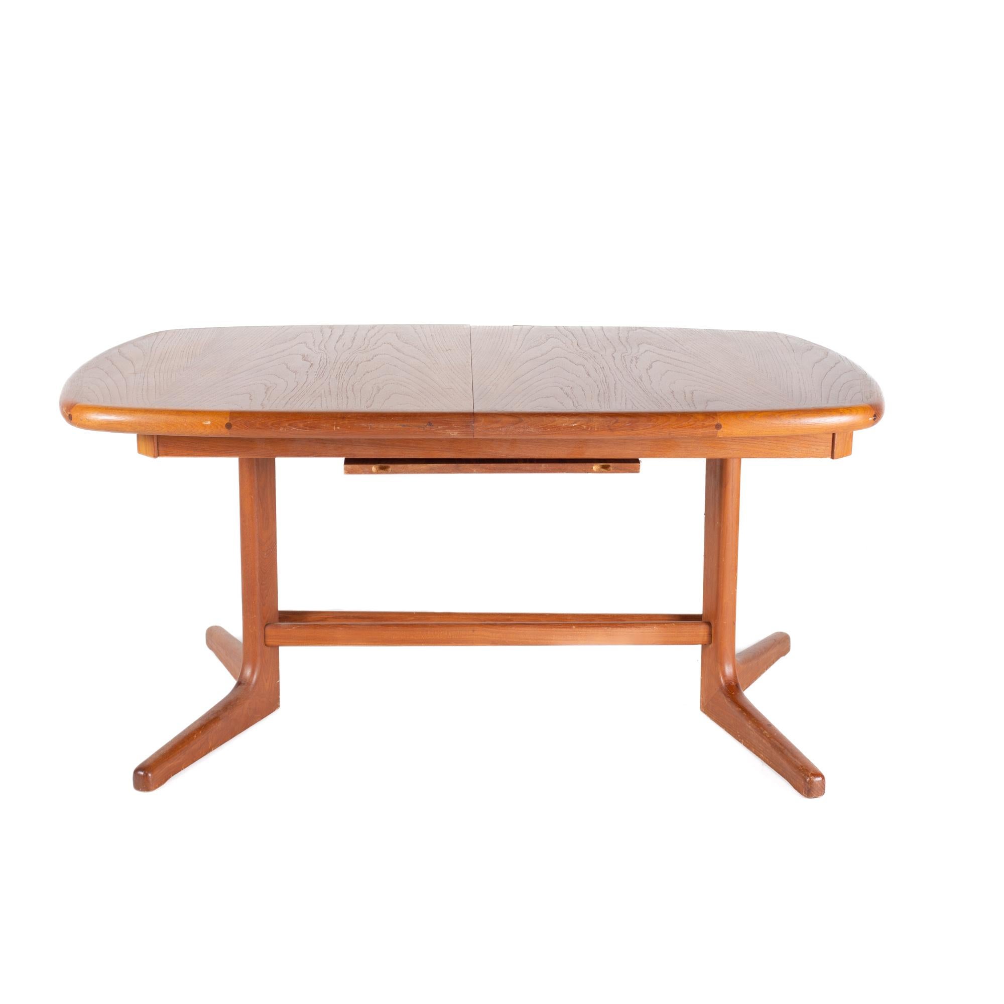 Dyrlund Style Mid Century Teak Hidden Leaf Dining Table

The table measures: 58 wide x 38 deep x 28 high, with a chair clearance of 24 inches; the leaf is 20 inches wide, making a maximum table width of 78 inches when the leaf is used

All
