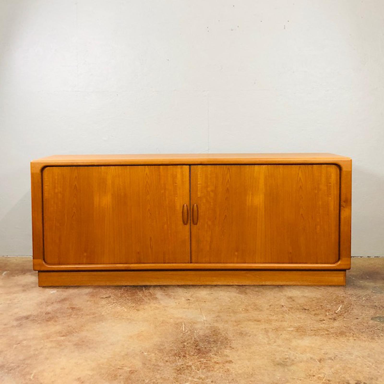 Early 1960s teak credenza by Dyrlund of Denmark. Clean with sculptural lines. Timeless modern. Original very good condition.