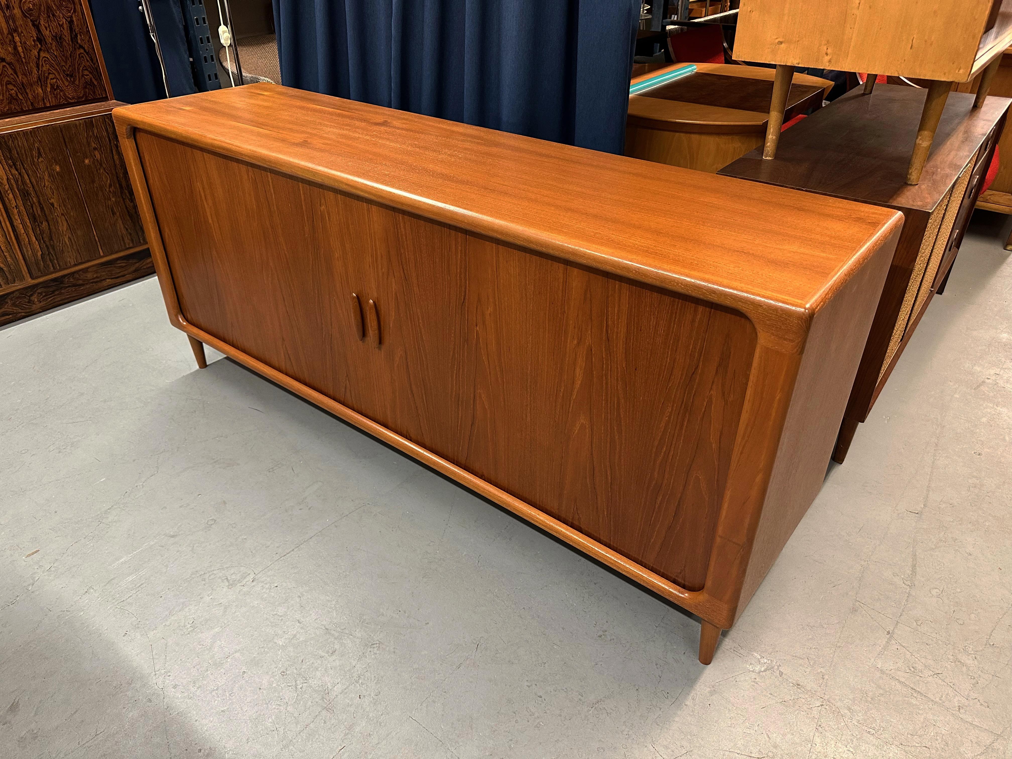 Beautiful 1960's Danish teak credenza by Dyrlund with the most impressive tambour doors we think we've ever seen.

The interior has 3 adjustable shelves and 5 drawers with dovetail joints.

Felt lined top drawer for silver storage.

In excellent