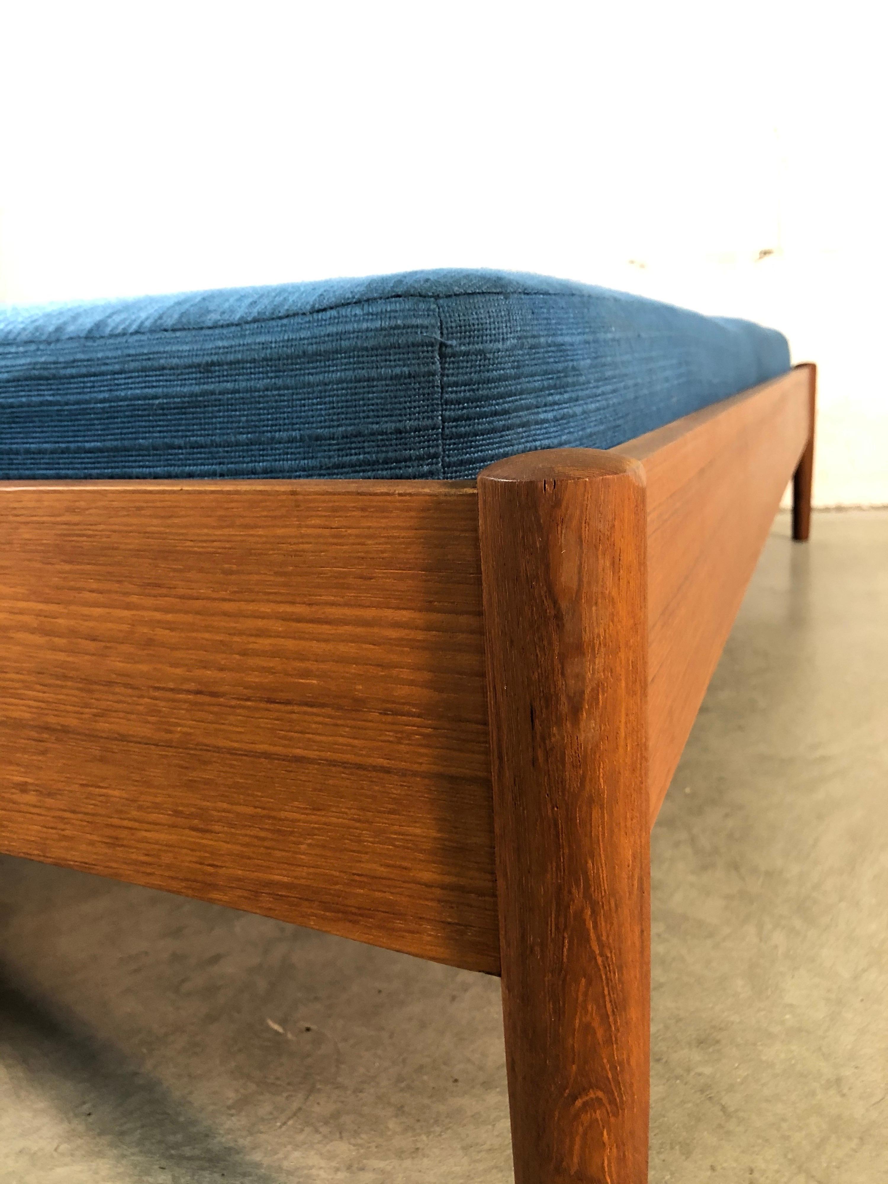 Vintage 1960s Danish teak daybed by Dyrlund. The bed is on a solid teak frame with the original fabric mattress. Very sturdy and in refinished condition. Marked with a label.