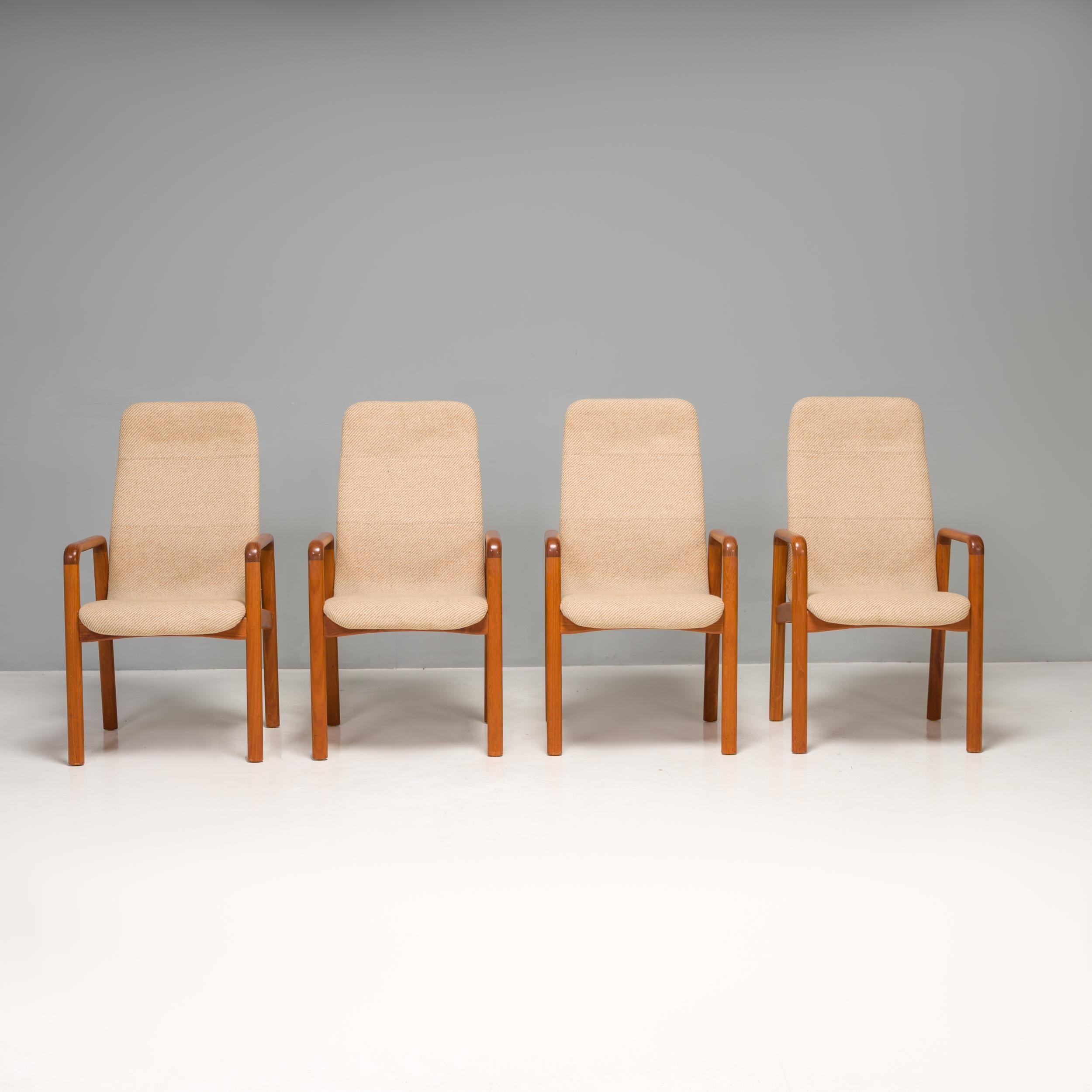 A fantastic example of midcentury Danish design, this set of chairs was manufactured by Dyrlund.

Constructed from teak frames with softly curved armrests and cylindrical legs, the chairs have an organic Silhouette with high backs for extra