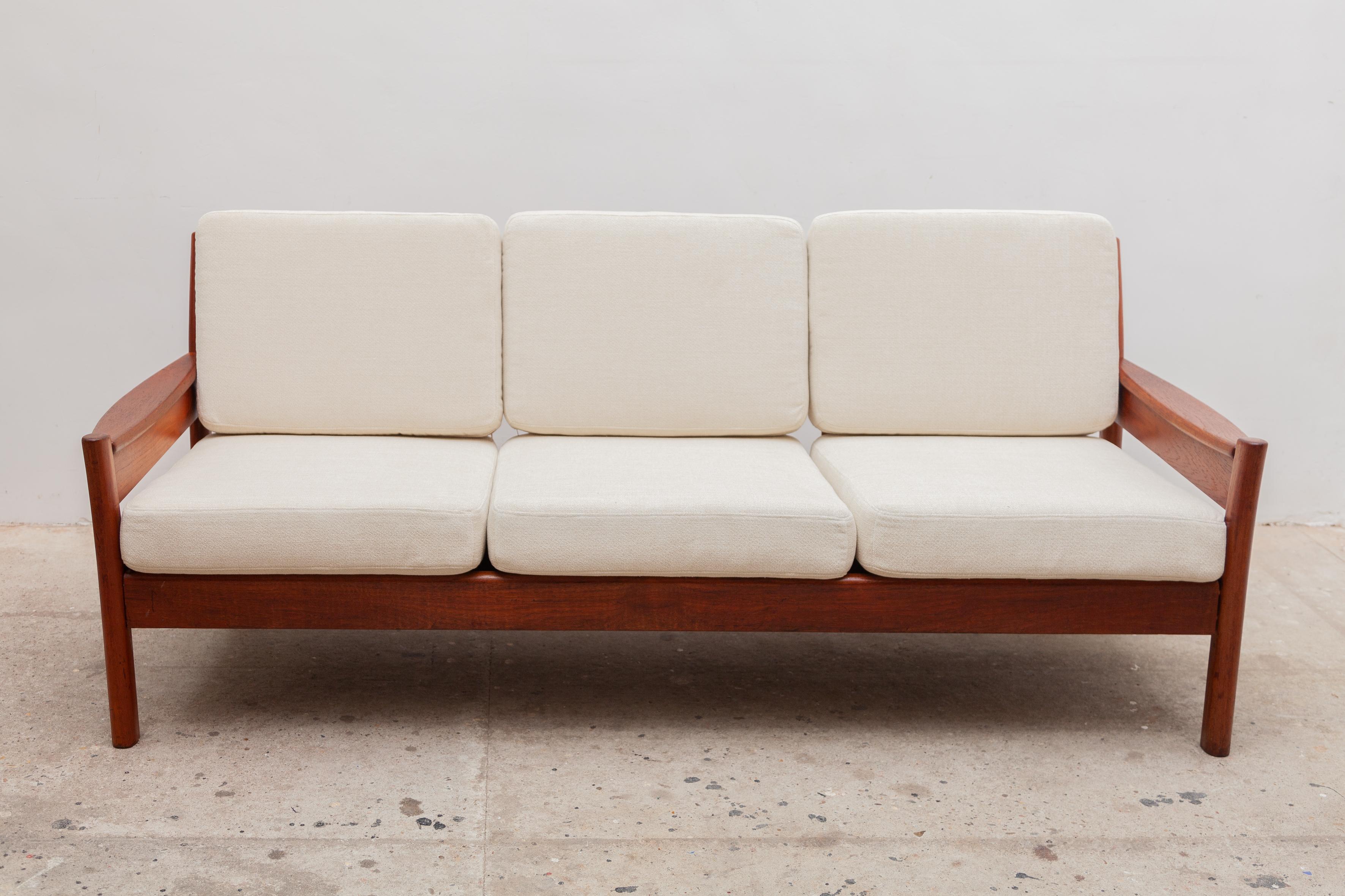 Vintage midcentury three-seat sofa by Dyrlund, Denmark. Elegant solid teak frame with new cream wool woven upholstery.
Dimensions: 190 W x 70 H x 75 D cm, seat 41 cm high.
 