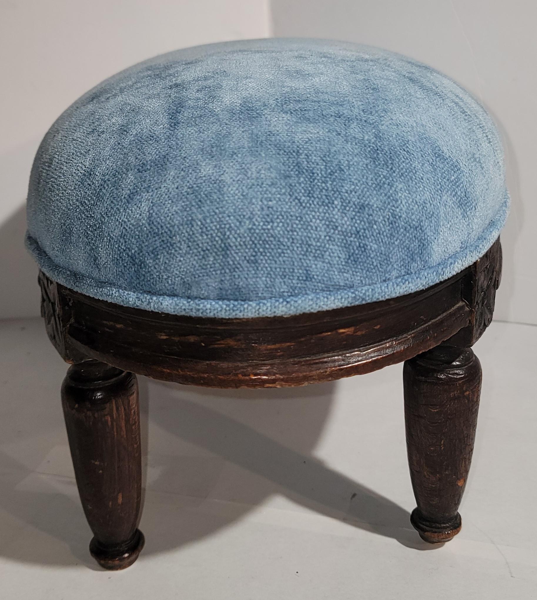 Beautiful foot stool, wooden design with original stain. The vintage velvet fabric is clean. This foot stool has wear to the legs from age and use, very minor wear.  A beautiful puffy oval foot stool. 