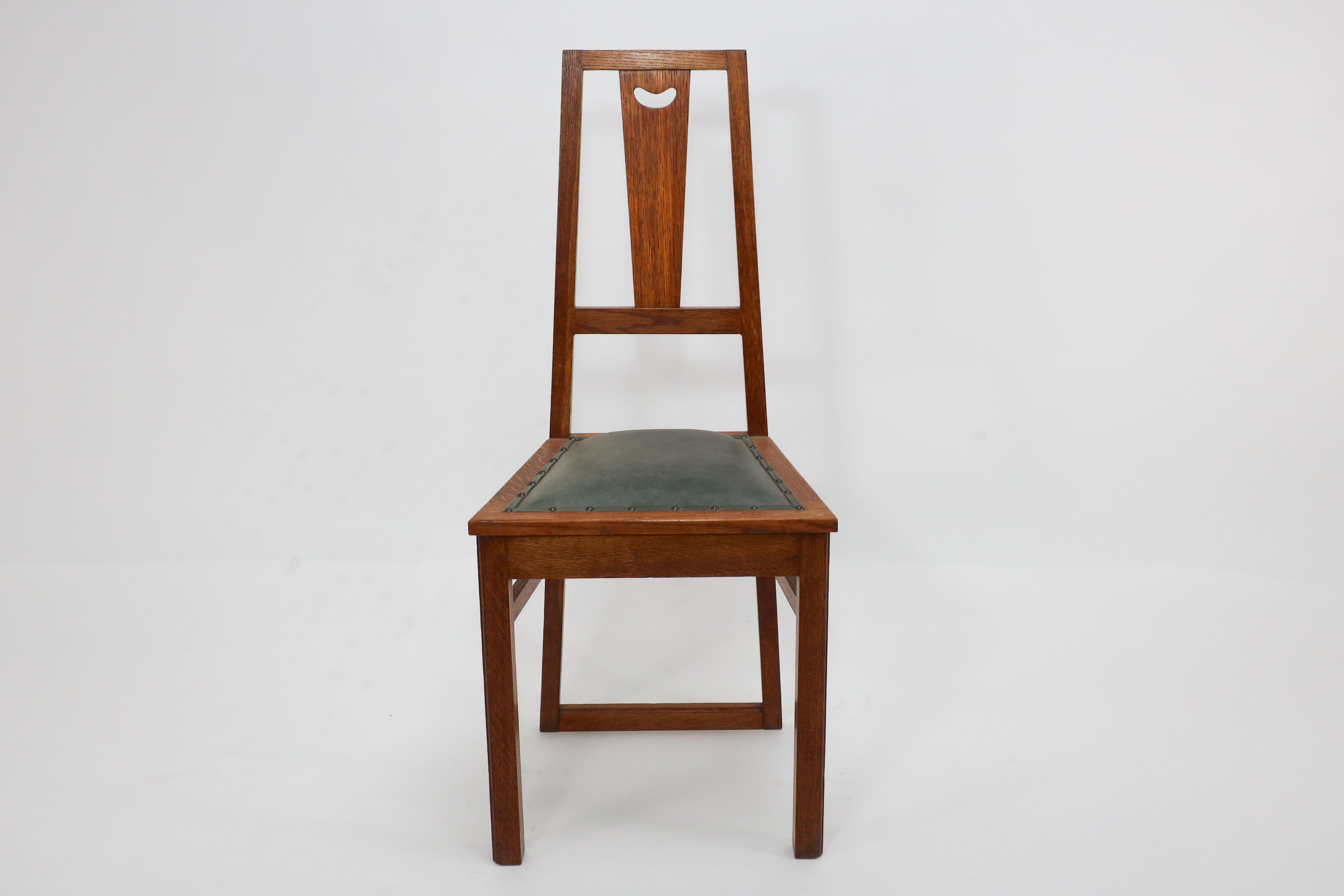 English E A Taylor. A set of five Arts and Crafts oak side chairs with heart cut-outs. For Sale