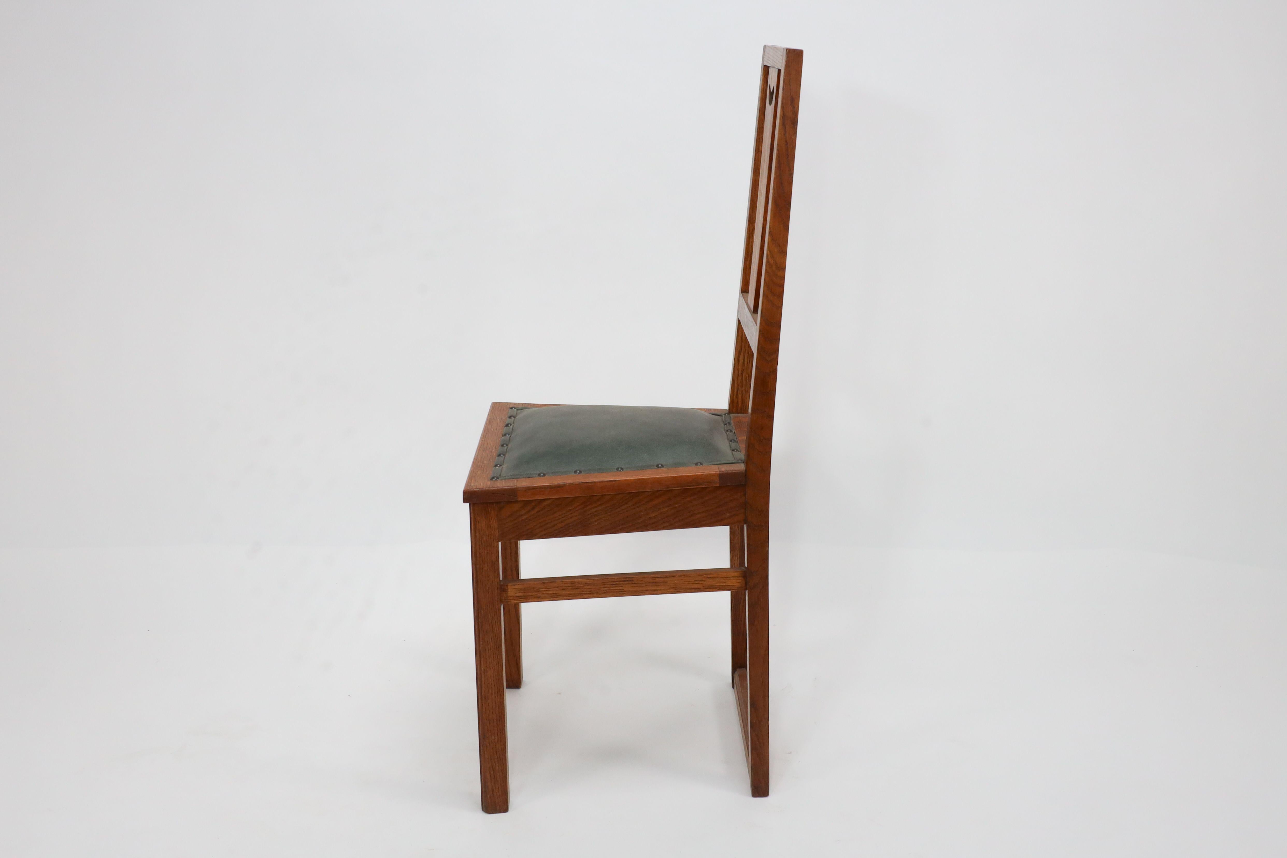 Early 20th Century E A Taylor. A set of five Arts and Crafts oak side chairs with heart cut-outs. For Sale