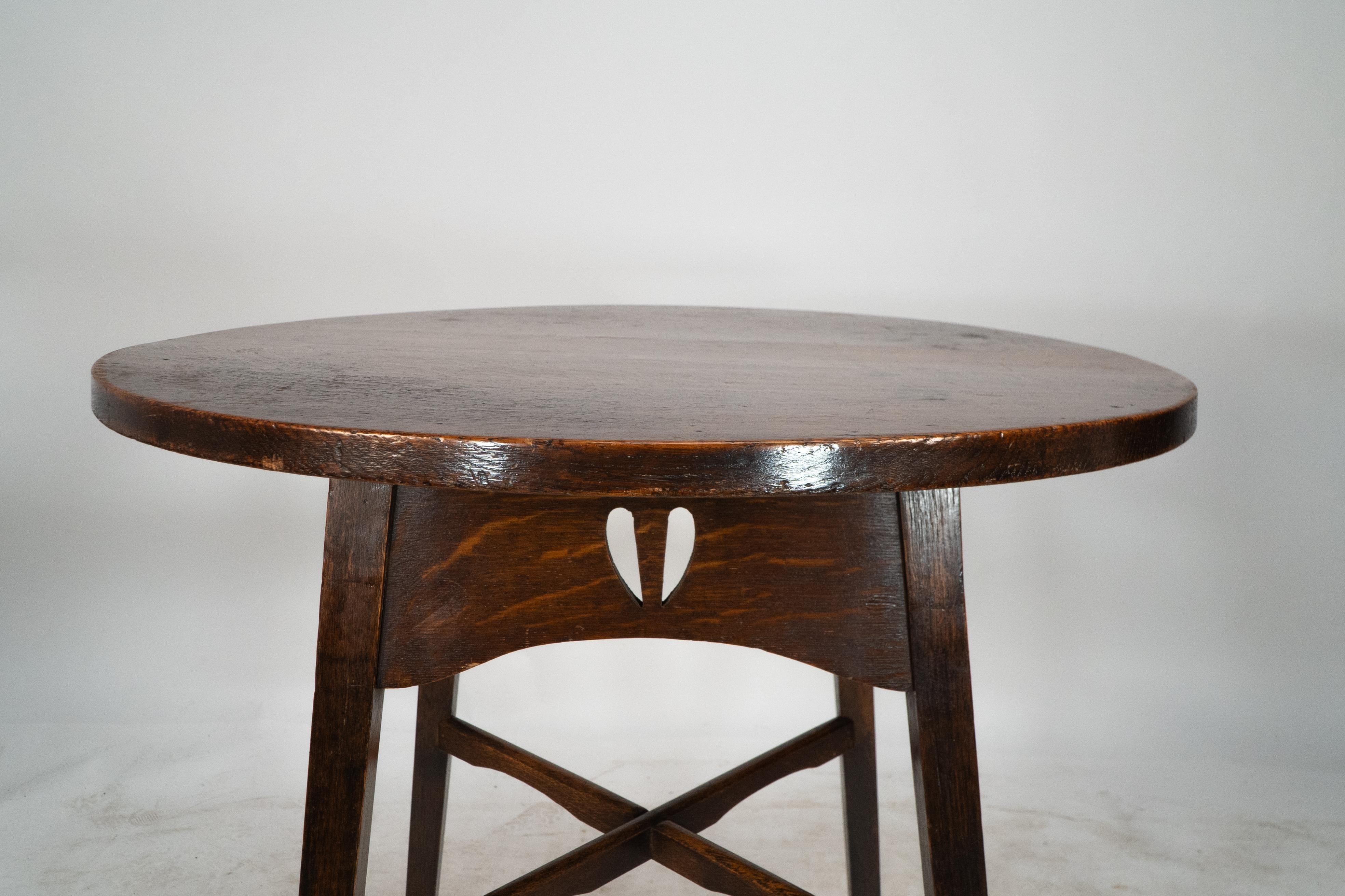 Early 20th Century E A Taylor for Wylie and Lochhead. A Glasgow school circular oak side table For Sale