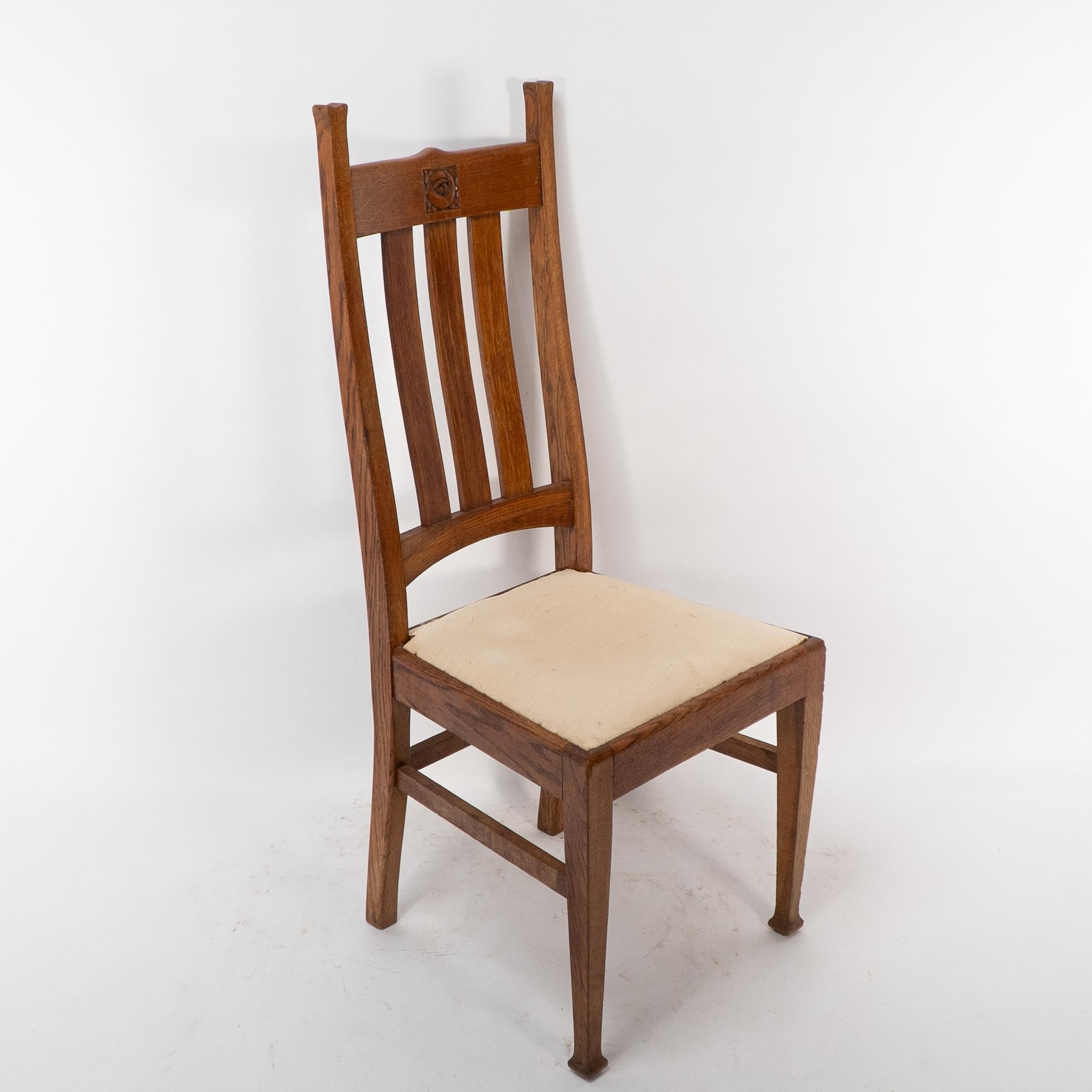Early 20th Century E A Taylor for Wylie & Lochhead. A set of four Arts and Crafts oak dining chairs For Sale