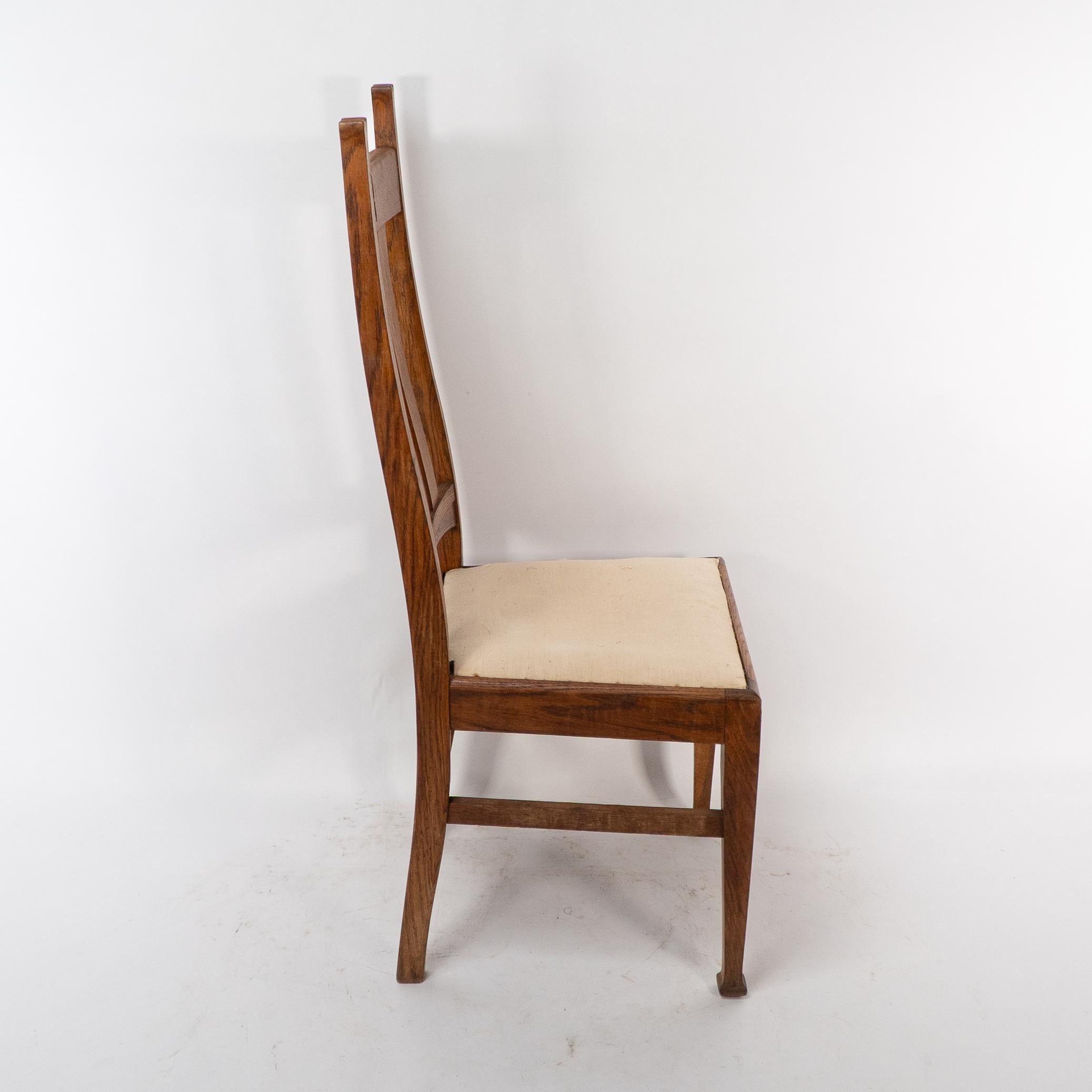 Oak E A Taylor for Wylie & Lochhead. A set of four Arts and Crafts oak dining chairs