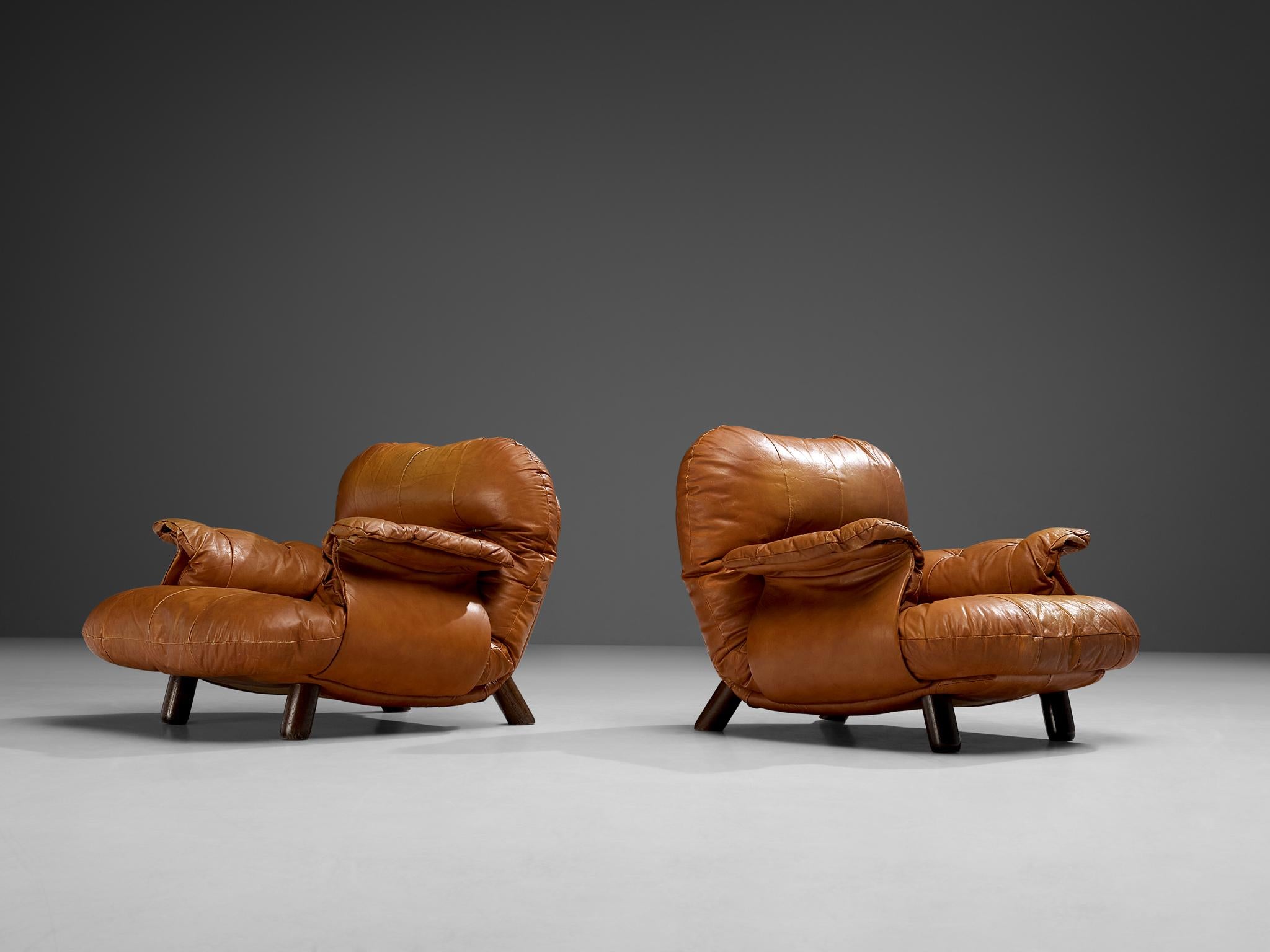 E. Cobianchi for Insa, pair of lounge chairs, leather and wood, Italy, 1970s

An Italian set of two bulky lounge chairs designed by E. Cobianchi. The lounge chairs feature thick, tufted seats and backrests. The armrests are curved in an extravagant