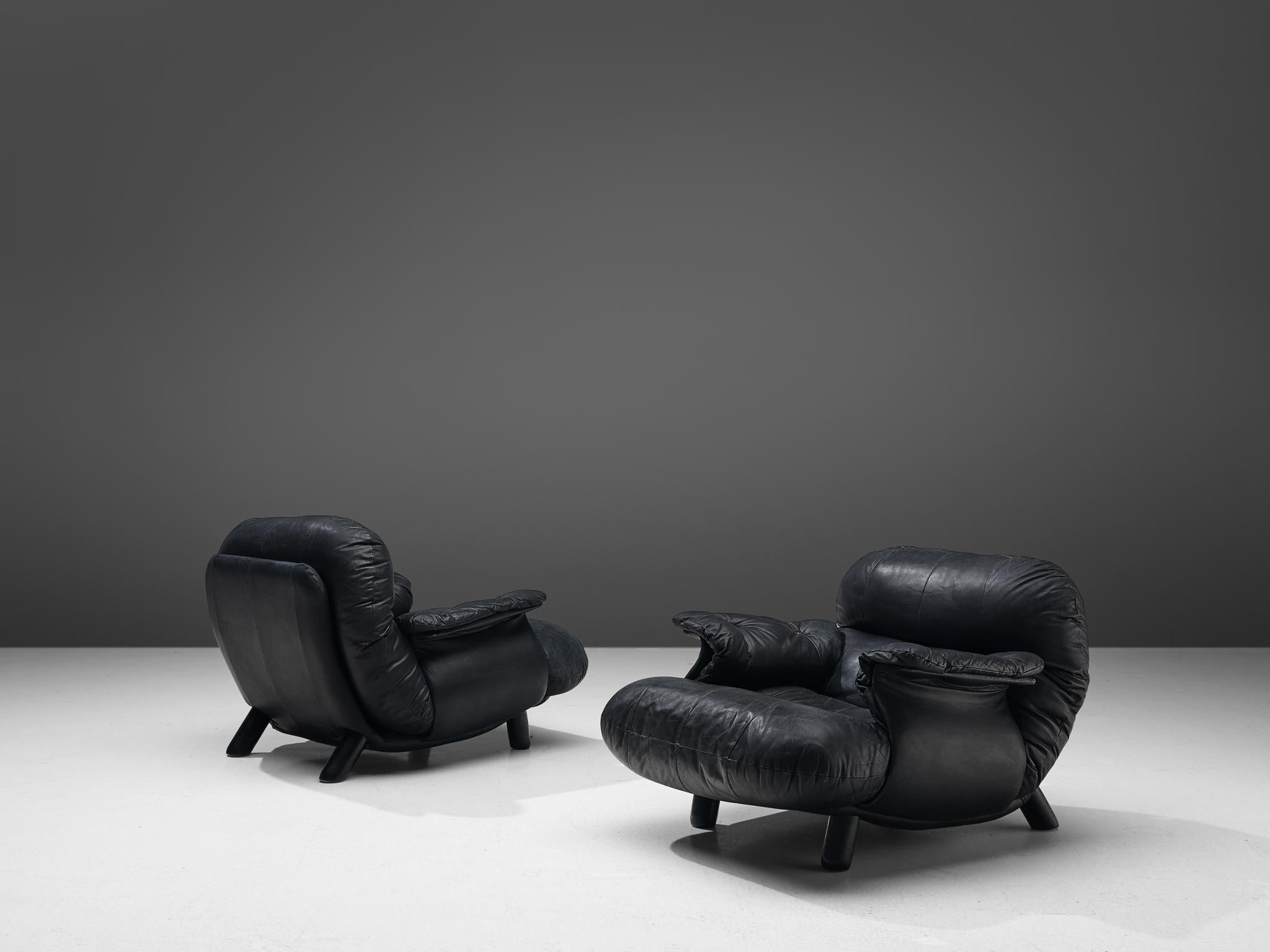E. Cobianchi for Insa, pair of lounge chairs, leather and wood, Italy, 1970s

An Italian set of two bulky lounge chairs designed by E. Cobianchi. The lounge chairs feature thick, tufted seats and backrests. The armrests are curved in an extravagant