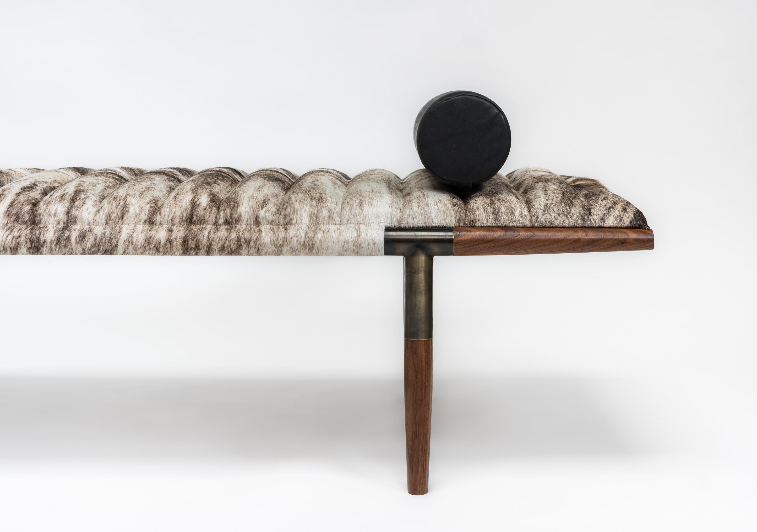 The EÆ daybed in ribbed grey Brazilian brindle hair-on-hide cushion with asymmetrically tapered oval black walnut legs and blackened brass frame.
Matching or custom contrasting bolster included.
This iconic design can be customized with different