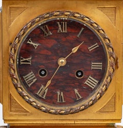 E. Reloj Figural Dumaige de Bronce Dorado y Patinado