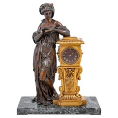 Figurale E. Dumaige-Uhr aus vergoldeter und patinierter Bronze
