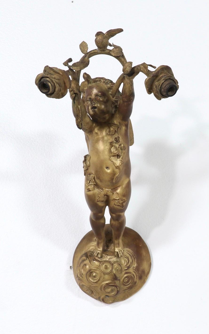 Rare and exceptional pair of bronze-doré winged putti sconces by E. F. Caldwell, New York.

Each sconce consists of an exquisitely sculptured bronze putti with fairy wings, floating on a cloud, holding a branch with a dove perched in the center