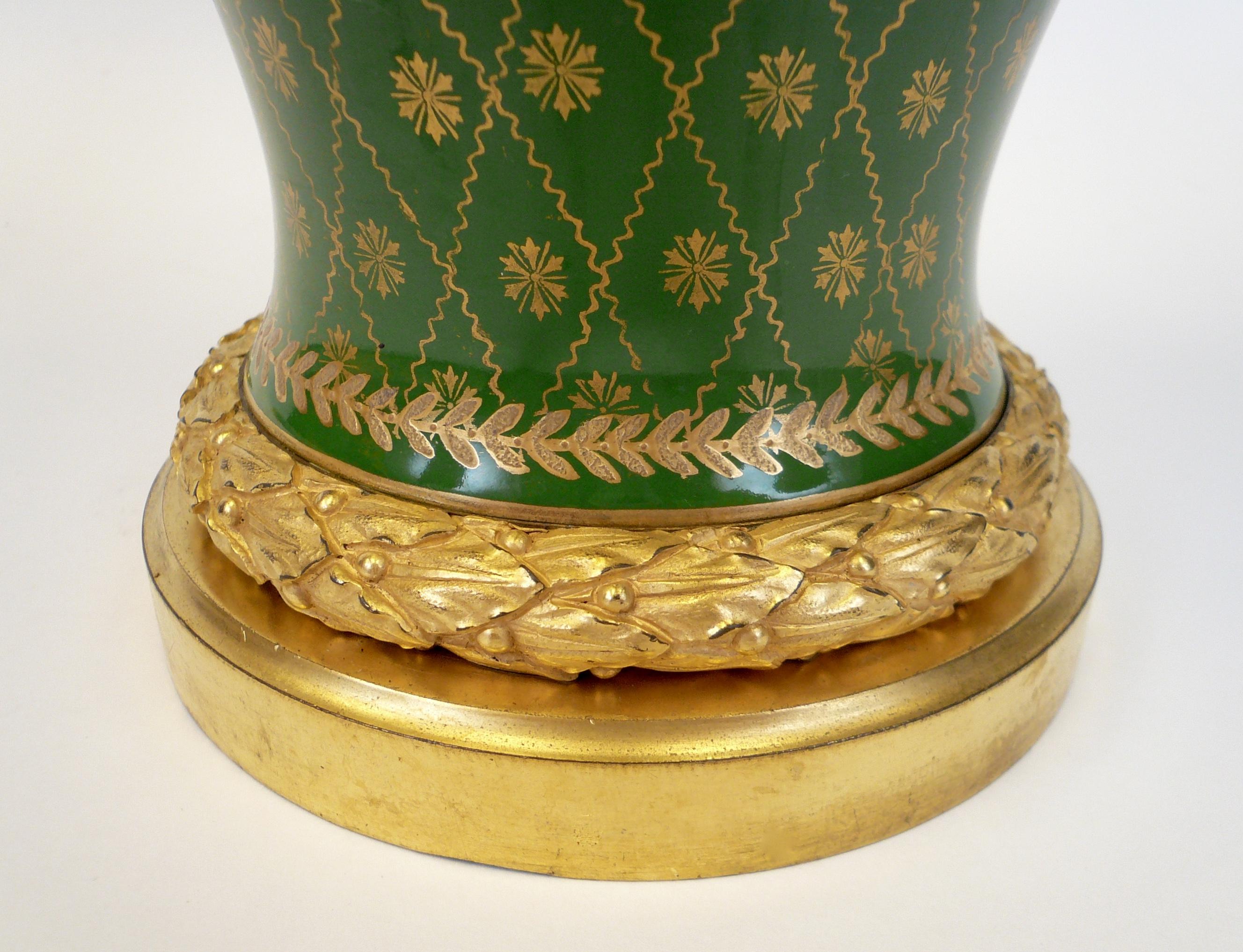 This French porcelain vase features hand painted roses and a gilt decoration. The gilt bronze mounts are by Caldwell and have hand chased details including acanthus leaves. The height of 23 inches includes the original finial.