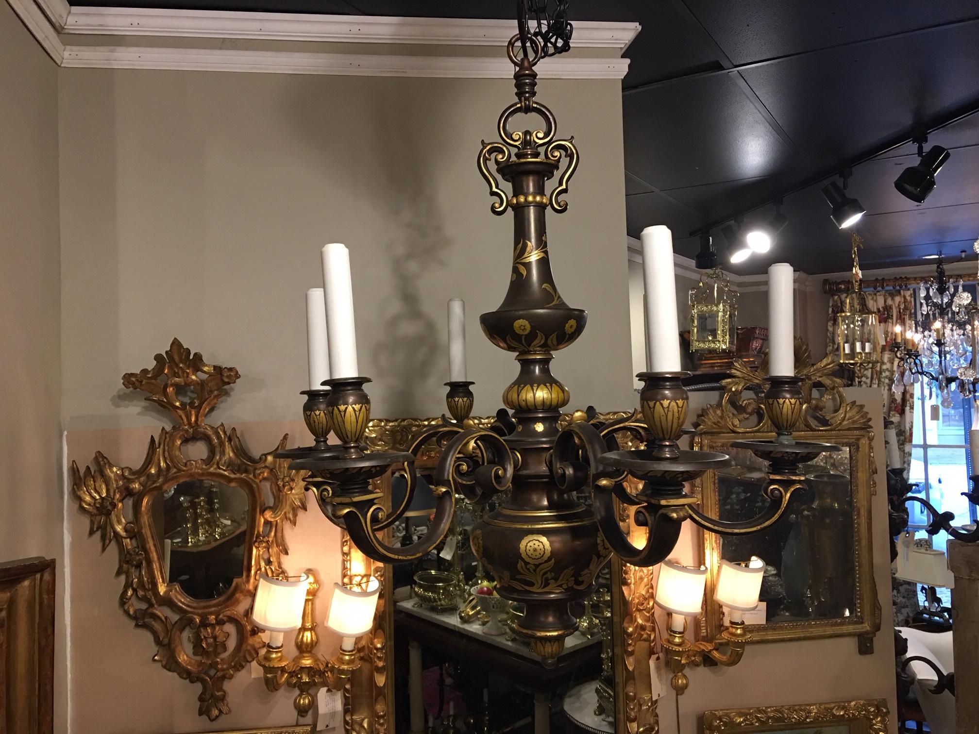A six-light Flemish style chandelier with a full-figured baluster-form body. Bronze with gilded decorations by the New York maker E F Caldwell.