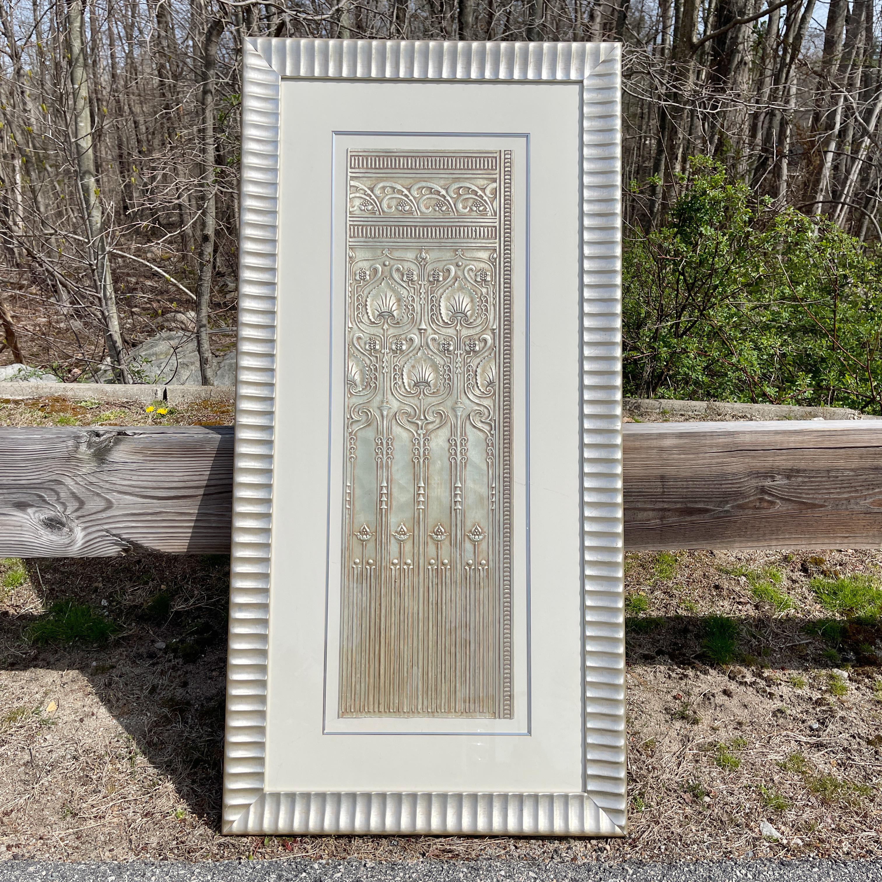 Embossed pewter plated paper panel elegantly mounted and framed in a silver gilt wood frame.
Label on verso 