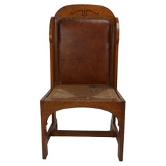 Antique E G Punnet attributed. Probably made by William Birch. An oak wing back chair