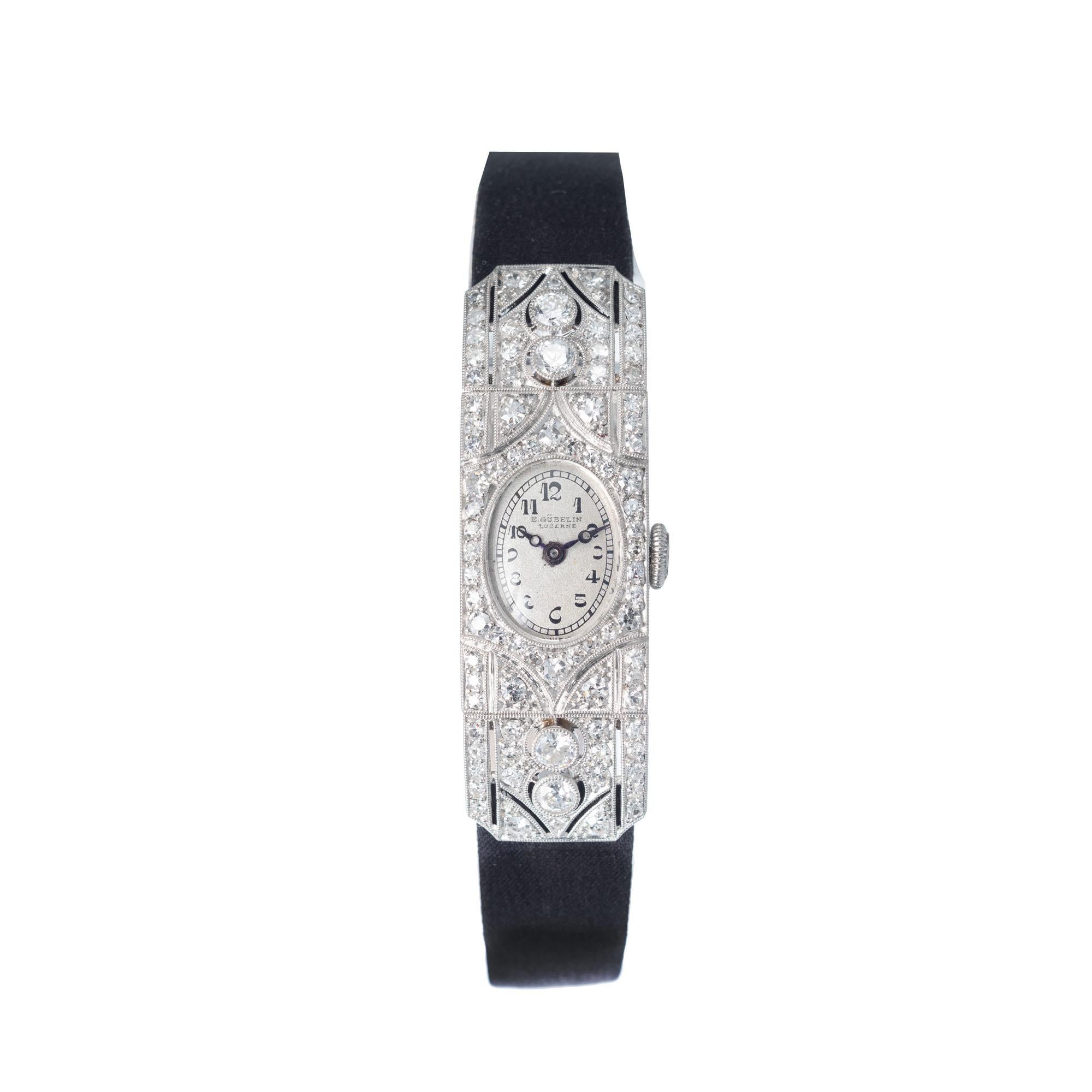 Ladies 1920's E. Gubelin Art Deco diamond ladies wristwatch. 17 jewel movement adjusted to 3 positions set with 86 old cut diamonds approximately 0.75 carats total. Pierced and engraved hinged case

Length: 42.85mm
Width: 13.64mm
Band width at case: