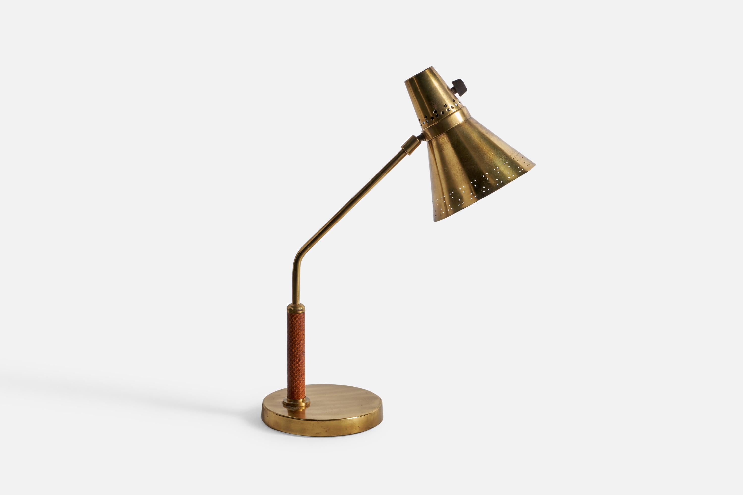 An adjustable brass and impressed leather table lamp designed and produced by E Hansson & Co, Malmö, Sweden, 1950s.

Overall Dimensions (inches): 18” H x 6.05” W x 14.1” D
Bulb Specifications: E-26 Bulb
Number of Sockets: 1
All lighting will be