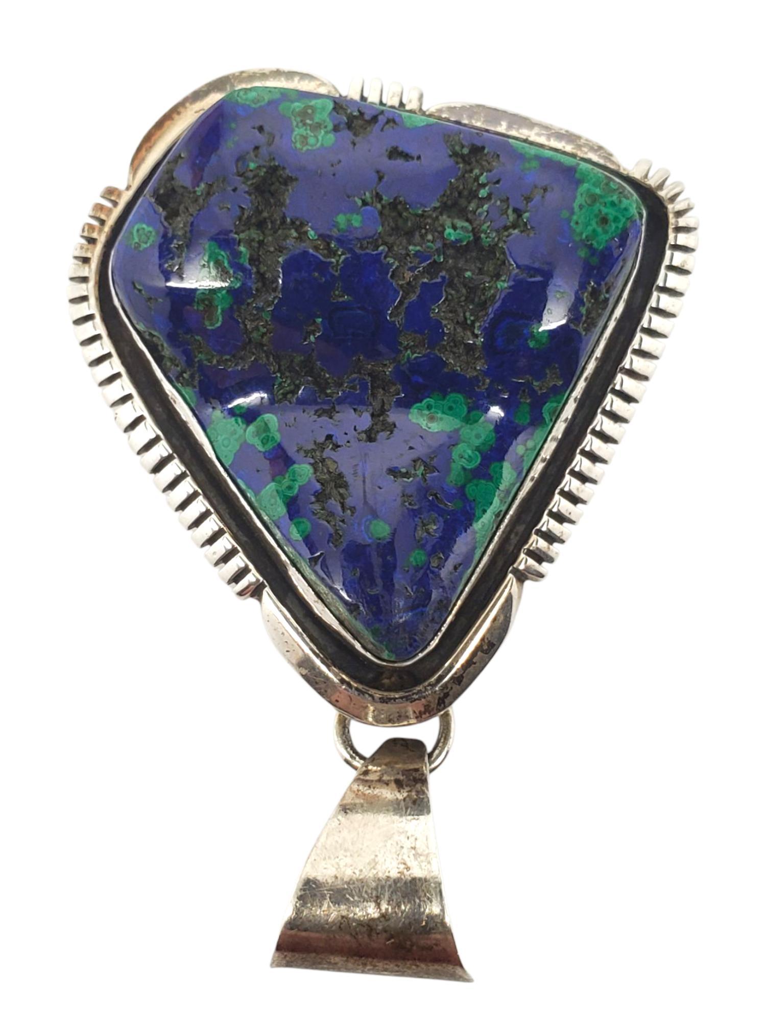 E. Ciondolo con cabochon blu e verde dei nativi americani KEI

Questo sorprendente ciondolo dei nativi americani di E. KEI presenta una pietra grezza blu e verde (30,3 mm x 27,8 mm) in una cornice triangolare incastonata in argento