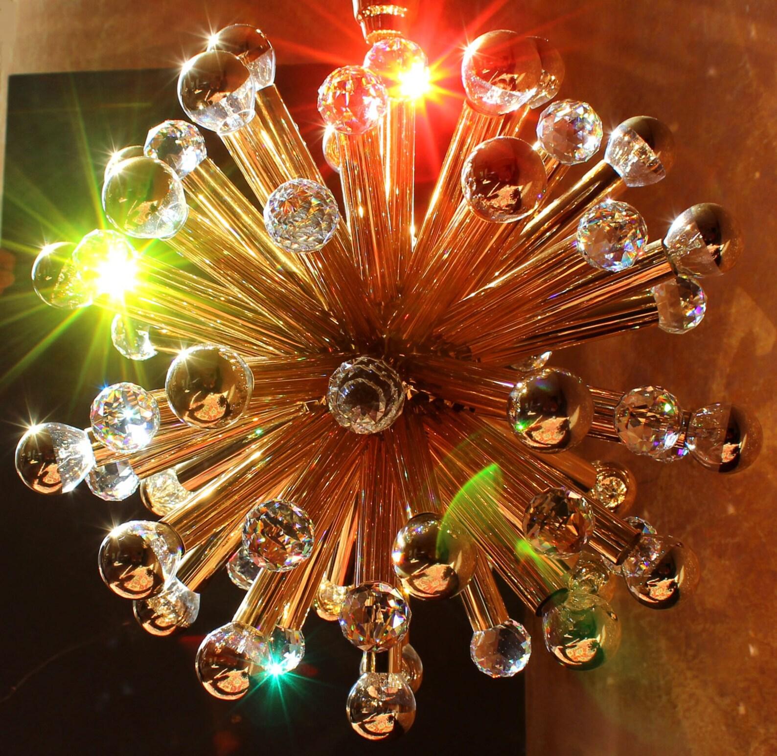 Ernst Palme gilt sputnik chandelier 1960's. gilded brass with large Swarovski balls.

Ernst Palme / Westheim chandelier 1960's. 33 lights (edison 14), diameter 20 inches, original total height 42 inches. 

The lighting manufacturer Ernst Palme