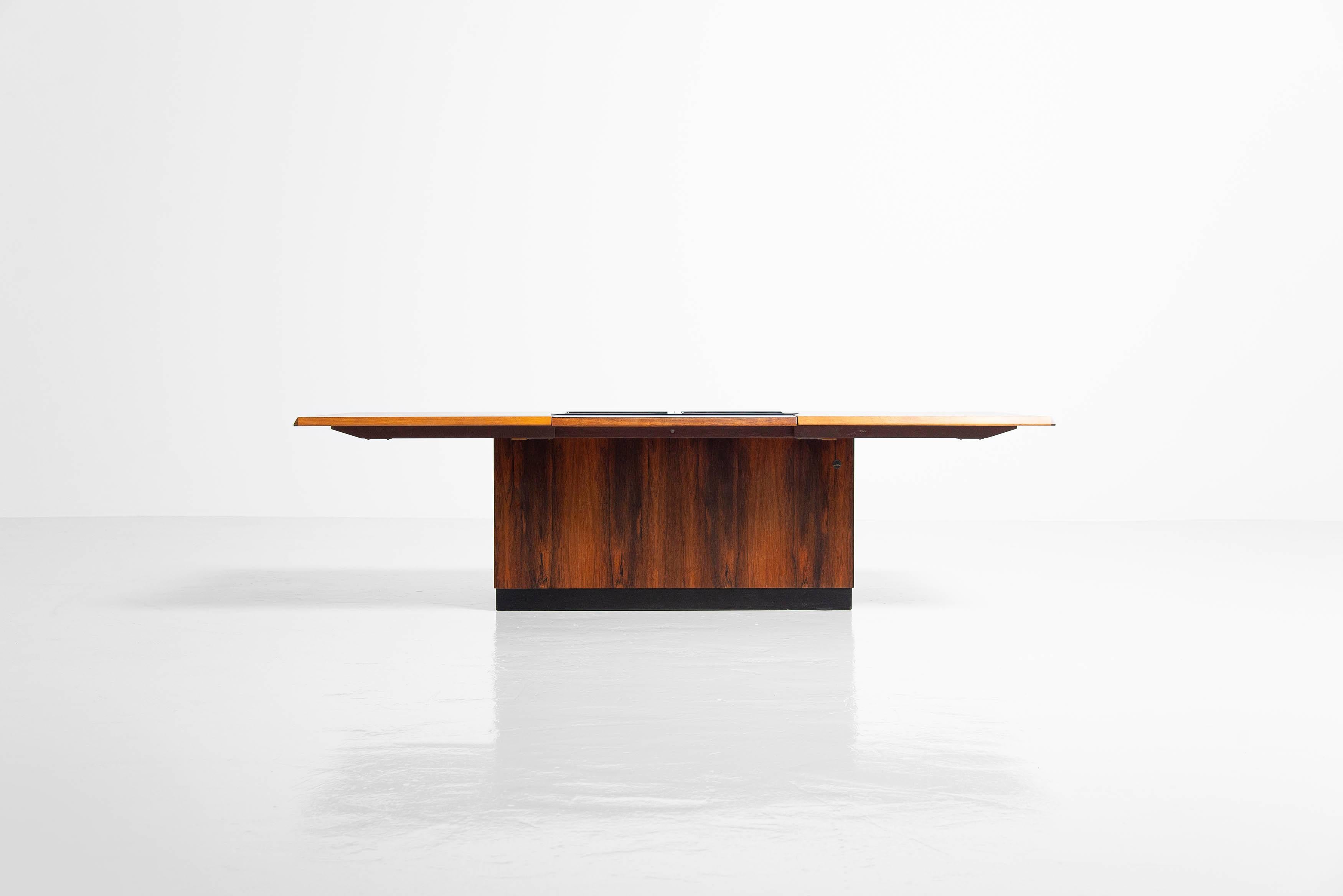 Super stylish coffee table with sliding top and hidden bar which is manufactured by E. Pedersen & Son a-s, Denmark 1960. This coffee table has a sliding top which opens the bar part on the inside, there will fit small and big glasses and drink