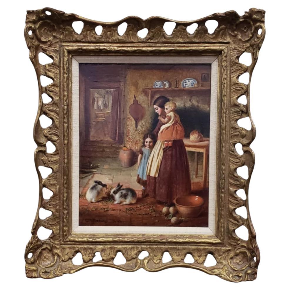 Este bello óleo sobre tabla es un ejemplo clásico de la pintura de género victoriana tardía, atribuido a E. S. Greig de Bristol. Titulada Alimentando a los Conejos, la obra capta un momento doméstico íntimo ambientado en el interior de una cabaña