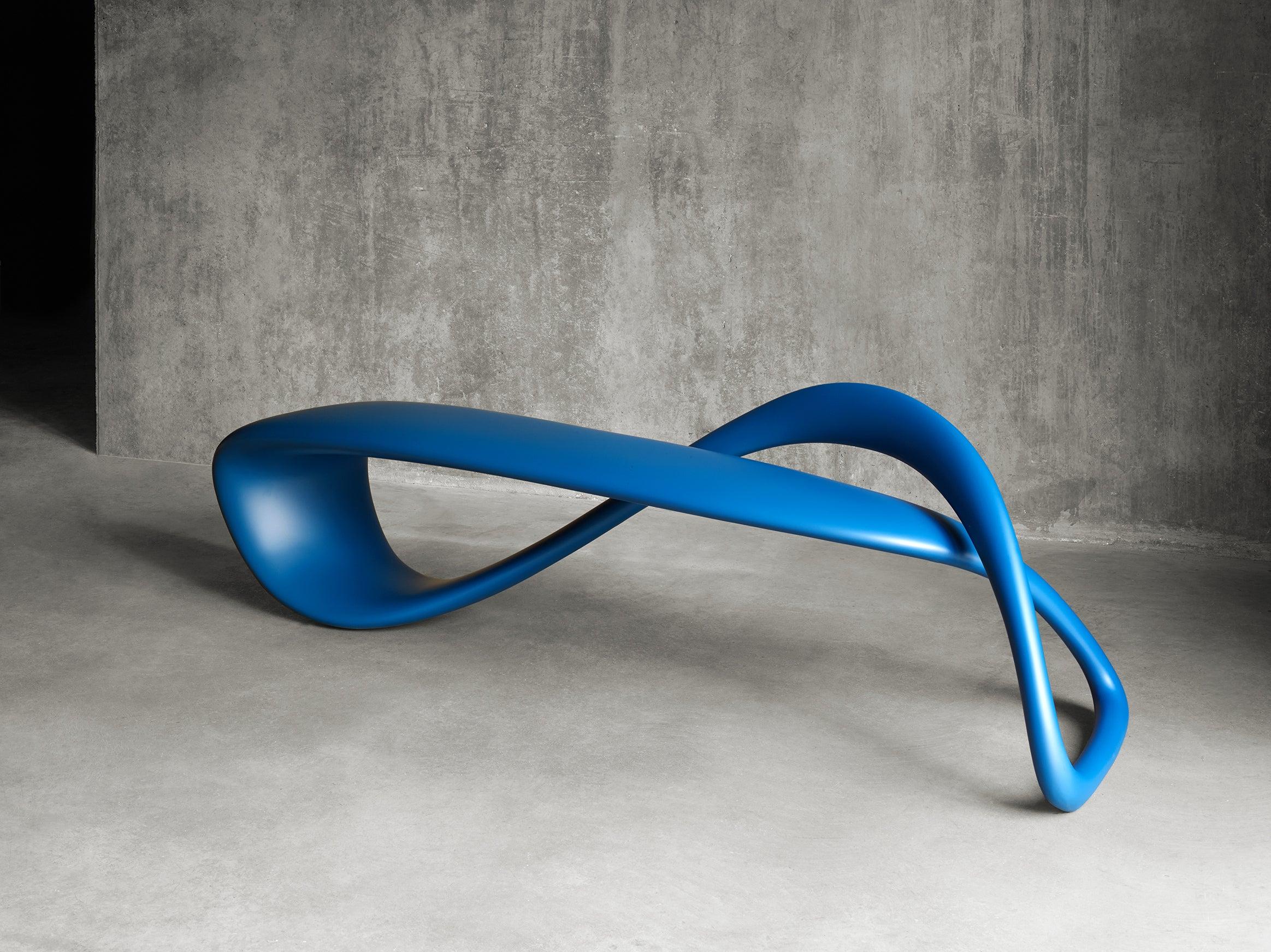 The result of exploring the possibilities of a singular line in 3D space, the E-Turn is a continuously morphing ribbon that twists and turns from seat to structure before overlapping and returning again in the configuration of a bench. The endless